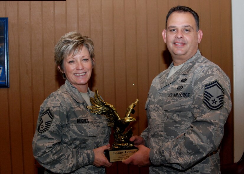 New Dobbins Top 3  president, Senior Master Sgt. Joy Hughes, Education and Training chief,  presents the Dobbins Top 3 Eagle trophy to former president, Senior Master Sgt. Larry Lopez, 22nd Air Force communications specialist, for his service to the Top 3 organization.  The Top 3 Eagle is traditionally presented to retiring presidents and vice-presidents of the organization.  (U.S. Air Force photo by Master Sgt. Stan Coleman)