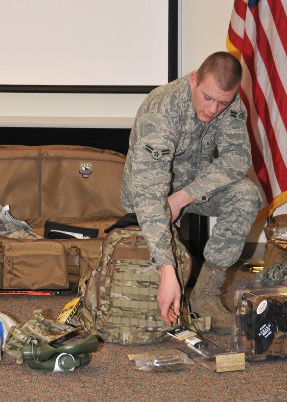 Airman 1st Class Christopher Munro displays equipment during a pre-deployment briefing at the 141st CES at Fairchild Air Force Base, Wash. on Jan. 7, 2012. (U.S. Air Force photo by Master Sgt. Mindy Gagne) 
