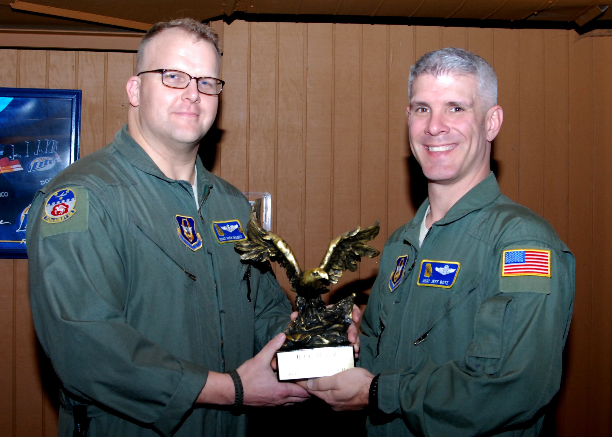 New Dobbins Top 3 vice president, Master Sgt. Rich Graddy, presents the Dobbins Top 3 Eagle trophy to former vice-president Master Sgt. Jeff Botz for his service to the Top 3 organization.  Both men are loadmaster instructors and flight chiefs with the 700th Airlift Squadron.  The Top 3 Eagle is traditionally presented to retiring presidents and vice-presidents of the organization.  (U.S. Air Force photo by Master Sgt. Stan Coleman)