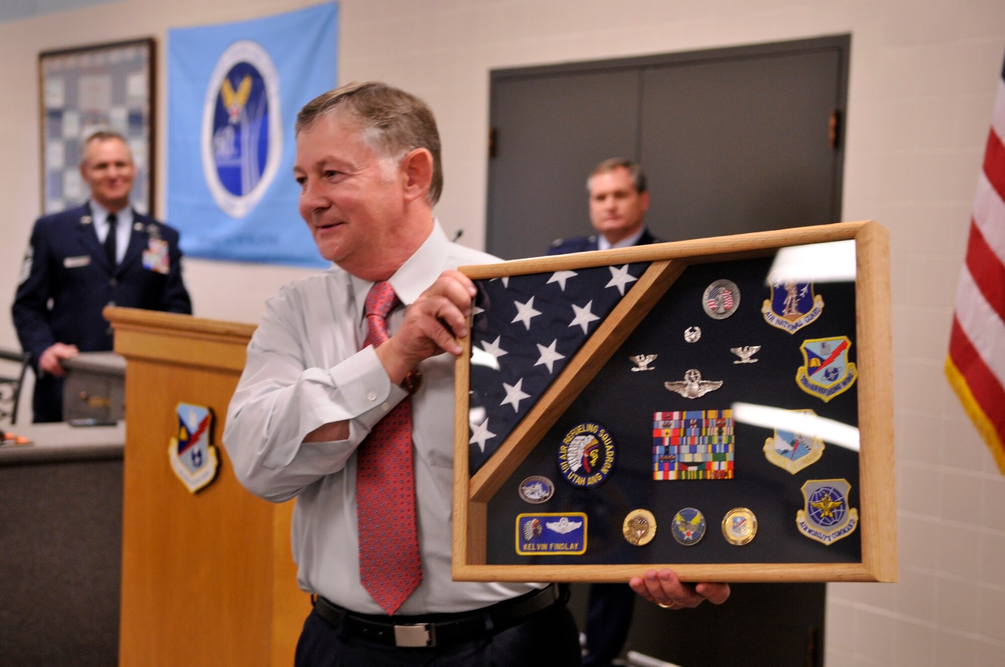 U.S. Air Force Col. Kelvin G. Findlay displays a shadowbox given to him at his retirement ceremony at the Utah Air National Guard Base, Salt Lake City, Utah, January 7, 2012. Findlay served for 32 years in the Utah Air National Guard before retiring from military service. (U.S. Air Force Photo by TSgt Jeremy Giacoletto-Stegall/Released)