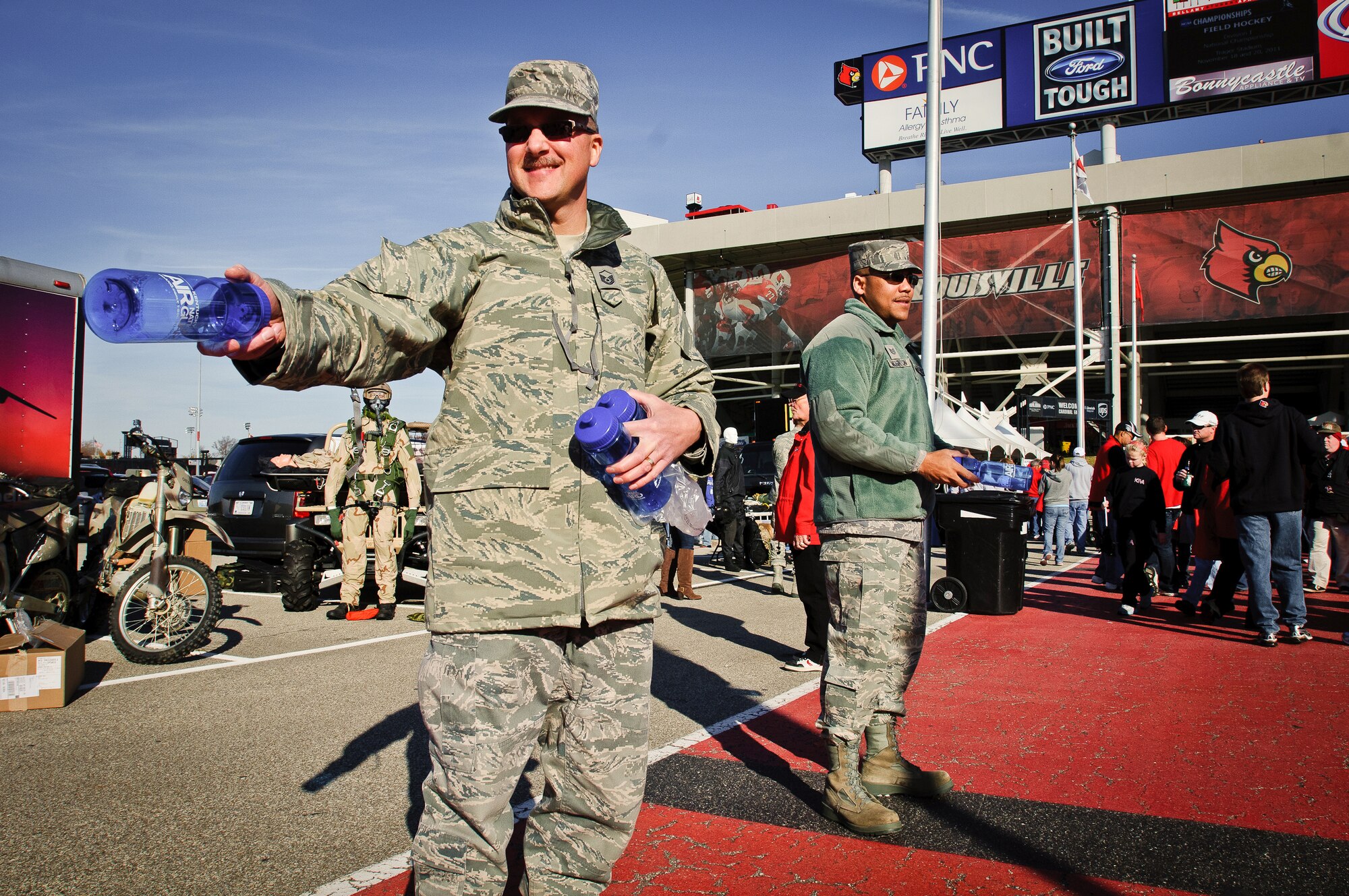 Master Sgt. Ted Bothur, a recruiter with the Kentucky Air National Guard, hands out water bottles to fans entering University of Louisville Cardinal Stadium in Louisville, Ky., Nov. 12, 2011. The giveaway was part of the university's annual Military Appreciation Day, which took place this year on the same day as the U of L - Pittsburgh football game. (U.S. Air Force photo by Senior Airman Maxwell Rechel)