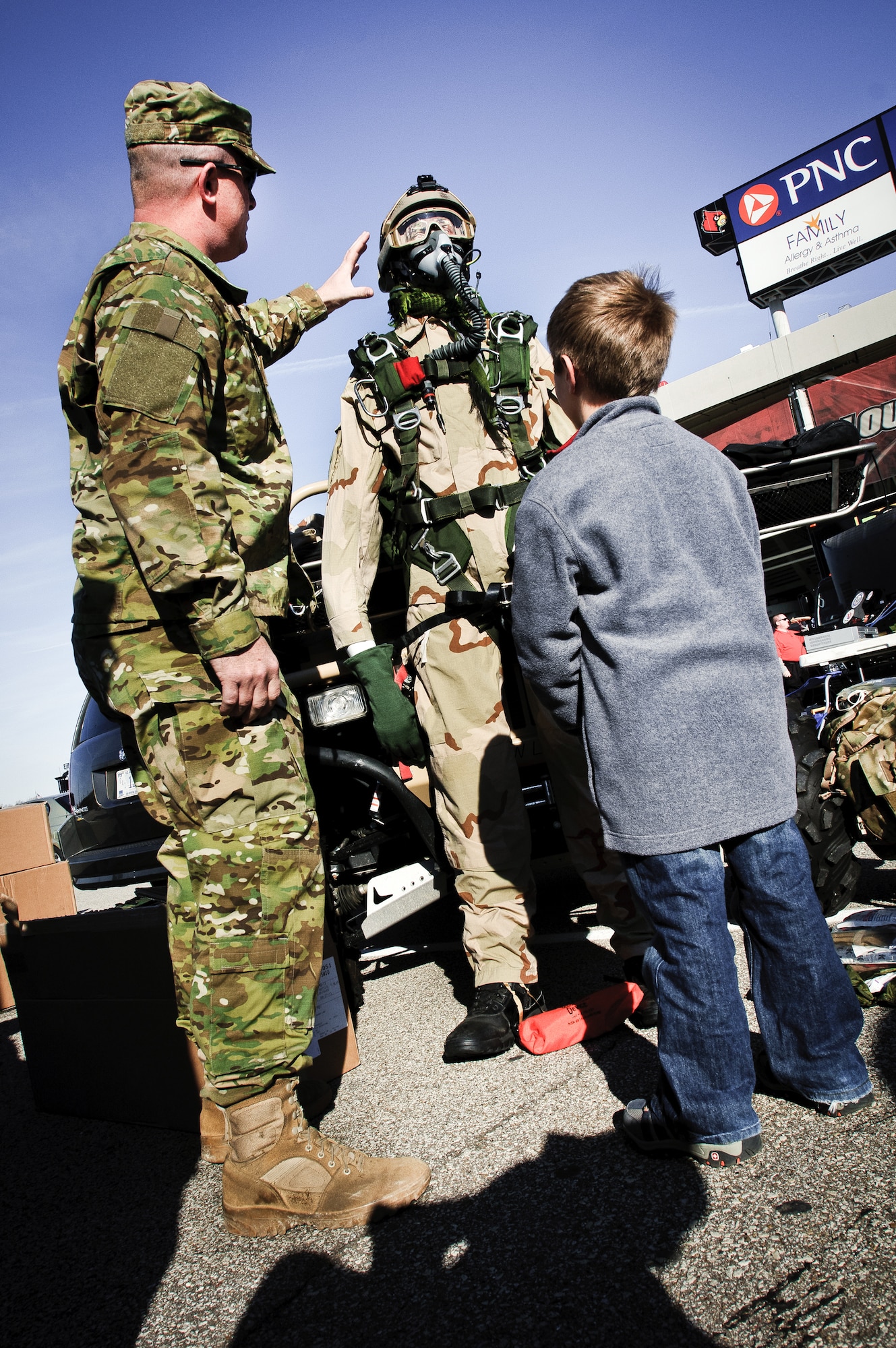 Tech. Sgt. Jason Likens of the Kentucky Air National Guard's 123rd Special Tactics Squadron explains high-altitude parachute gear to a potential recruit Nov. 12, 2011, at U of L Cardinal Stadium in Louisville, Ky. The display was held in conjunction with the school's annual Military Appreciation Day, which took place this year on the same day as the U of L - Pittsburgh football game. (U.S. Air Force photo by Senior Airman Maxwell Rechel)