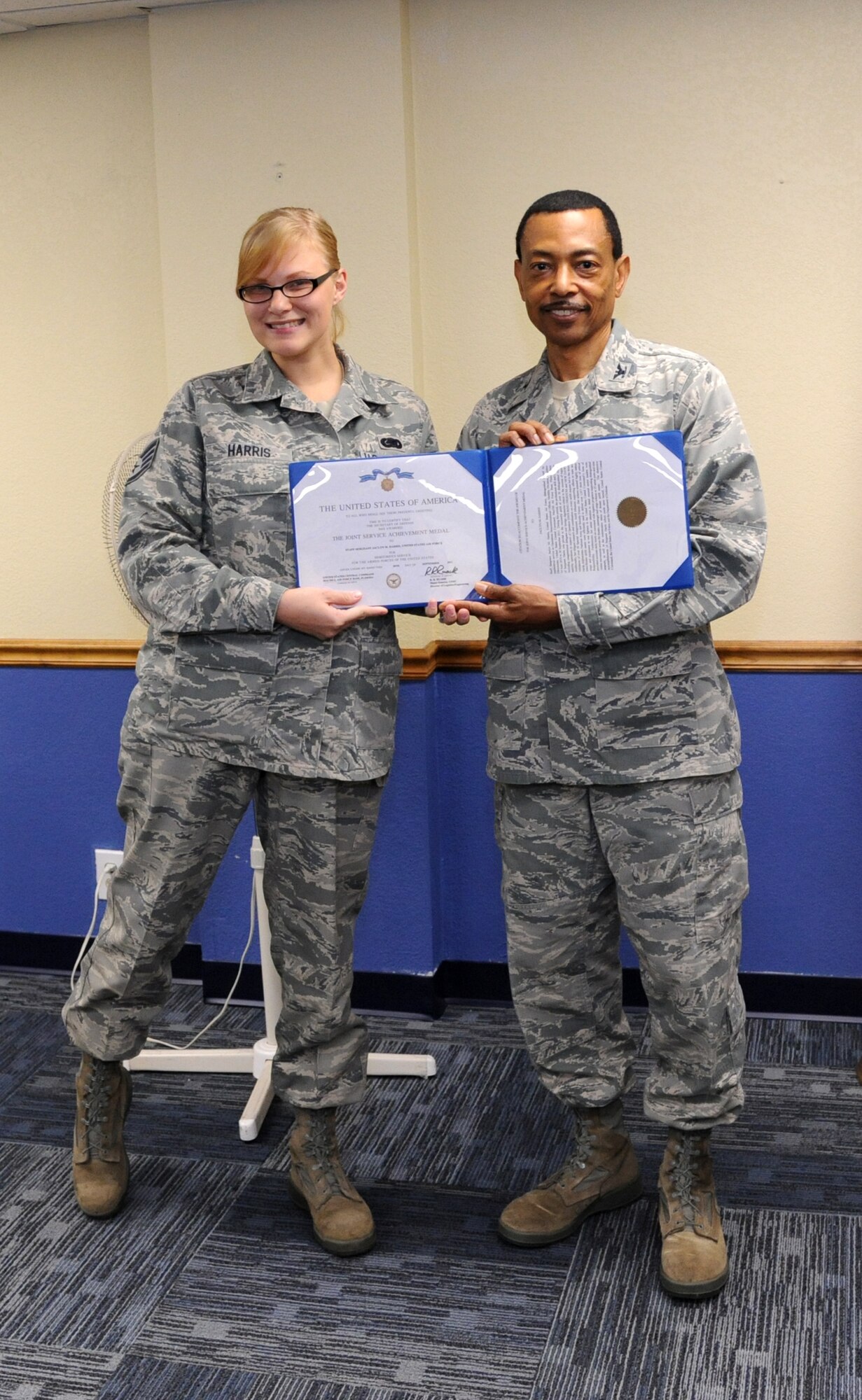 MacDill Air Force Base, Fla. --   Staff Sgt. Jaclyn Harris, a reservist with the 927th Air Refueling Wing, was recently awarded the Joint Service Acheivement Medal by Col. Rodney Bryan, commander of the 927th Mission Support Group.  Harris was recognized for her work with United States Central Command, where she was pivotal in conducting more than 50 airlift missions that equipped and trained Afghanistan national Army and Security Forces. (Official U.S. Air Force photo by Staff Sgt. Shawn Rhodes)