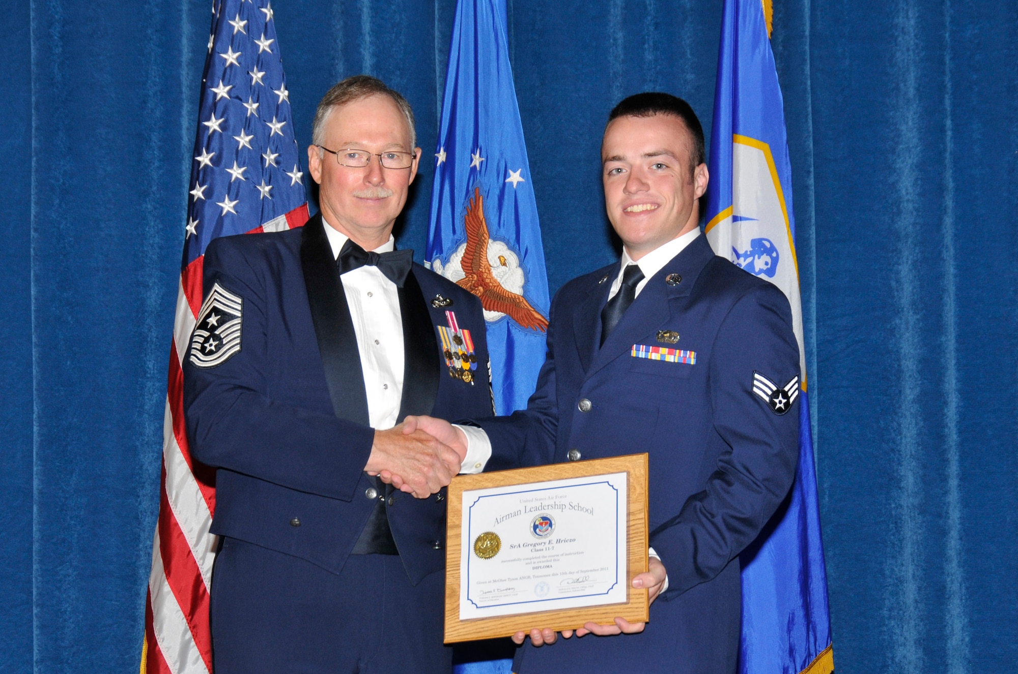 McGHEE TYSON AIR NATIONAL GUARD BASE, Tenn. – Air Force Reserve Senior Airman Greg Hrizco, right, receives the distinguished graduate award for Airman Leadership School Class 11-7 at The I.G. Brown Air National Guard Training and Education Center from Command Chief Master Sgt. Michael Dalton, Sept. 15, 2011. The distinguished graduate award is presented to students in the top ten percent of the class. It is based on objective and performance evaluations, demonstrated leadership and performance as a team player. U.S. Air Force photo by Master Sgt. Kurt Skoglund.