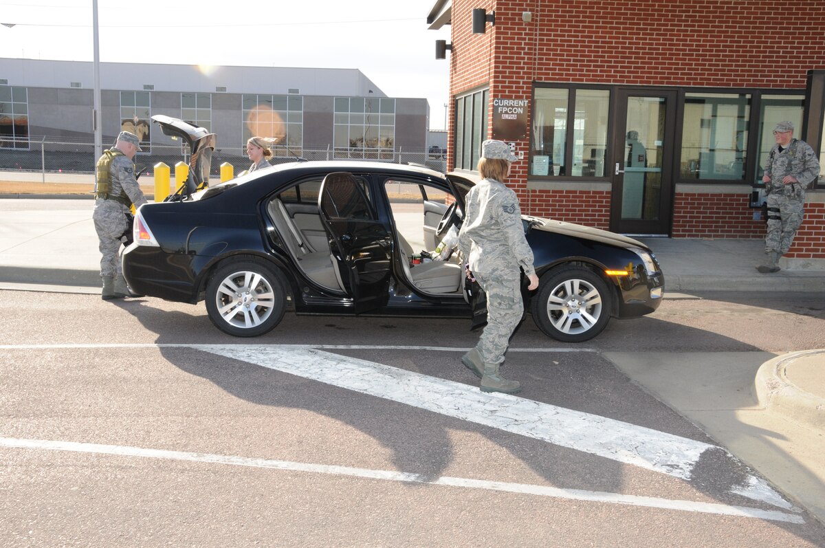 Sioux Falls, S.D. -- Staff Sgt. Eric Gage, 114th Fighter Wing Security Forces, conducts a random vehicle search at the main gate of Joe Foss Field, Jan. 7. Security personnel have been enjoying the unseasonably warm weather this winter in South Dakota. (National Guard photo by Master Sgt. Christopher Stewart)(Released)