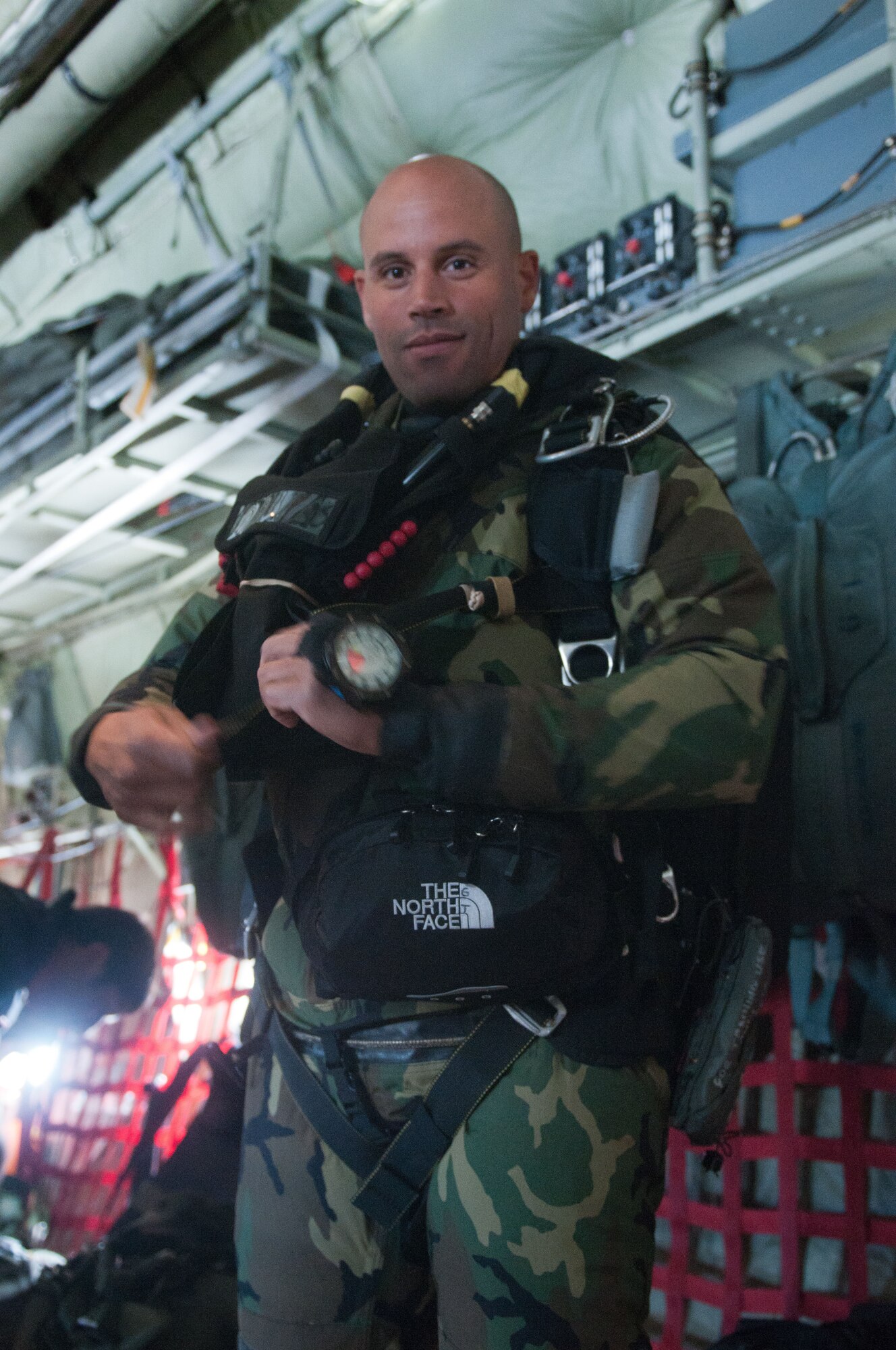 Staff Sgt. Jeff Gantt, a pararescueman from the Kentucky Air National Guard's 123rd Special Tactics Squadron, prepares his gear June 19, 2011, before jumping from a Kentucky Air Guard C-130 as part of a Precision Jumpmaster Course taught by members of the unit. The training is mandatory for all pararescuemen to attain a Craftsman skill level. (U.S. Air Force photo by Master Sgt. Phil Speck)