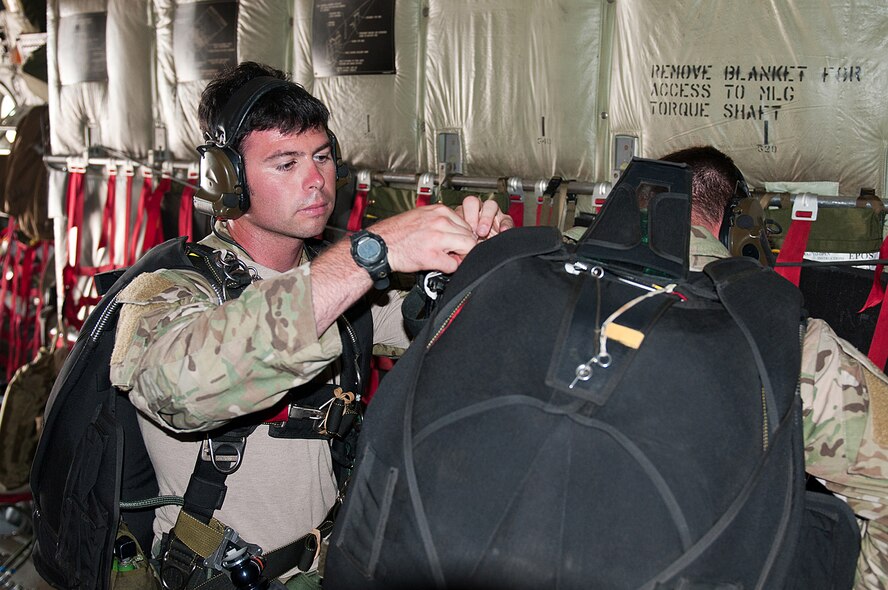 Staff Sgt. George Reed, an Air Force active-duty pararescueman from the 38th Rescue Squadron at Moody Air Force Base, Ga., checks his fellow pararescueman’s parachute gear June 14, 2011, before they parachute into Camp Atterbury, Ind., during a Precision Jumpmaster Course. The training, conducted by members of the 123rd Special Tactics Squadron, was made possible in part because of the squadron’s access to C-130 airlift provided by the 123rd Airlift Wing, the main operational unit of the Kentucky Air Guard. (U.S. Air Force photo by Master Sgt. Phil Speck)