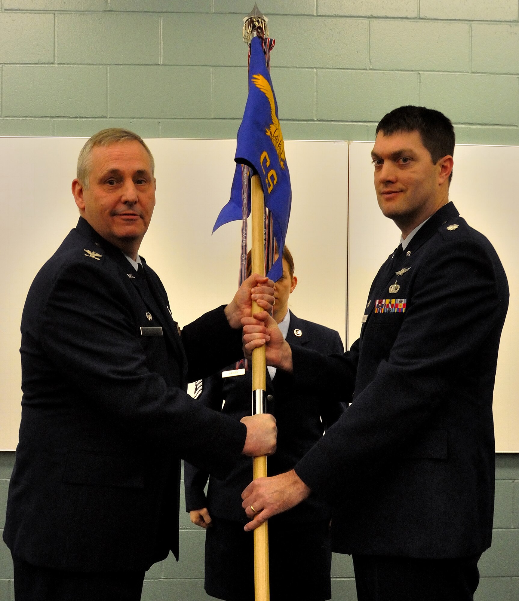 The 934th Airlift Wing Communications Flight officially became the Communications Squadron during a re-designation ceremony Saturday.  Lt. Col. Richard Erredge, Communications Squadron commander, assumed command of new squadron with the ceremonial acceptance of the Communications Squadron guidon from Col. Michael Ochs, 934th Mission Support Group commander. (Air Force Photo/Tech Sgt. Bob Sommer)