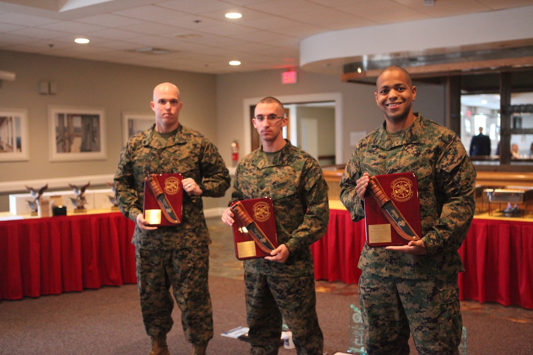 (From left to right), Sgt. Robert F. Lark, an expeditionary airfields systems technician with Marine Wing Support Squadron 273, Marine Wing Support Group 27, 2nd Marine Aircraft Wing, Marine Corps Air Station Beaufort, Cpl. Matthew S. Hamel, a distribution management specialist with Company A, Headquarters and Headquarters Squadron, Marine Corps Air Station Beaufort and Petty Officer 2nd Class Francisco Aquedamartinez, a corpsman with Deployment Processing Command-East, MCB Camp Lejeune during the 6th annual Marine Corps Installations East breakfast hosted by Mainstreet at the Ball Center aboard Marine Corps Base Camp Lejeune, Jan. 9. Businesses and agencies from the local community also resented the awardees with trophies and gifts for the accomplishments.