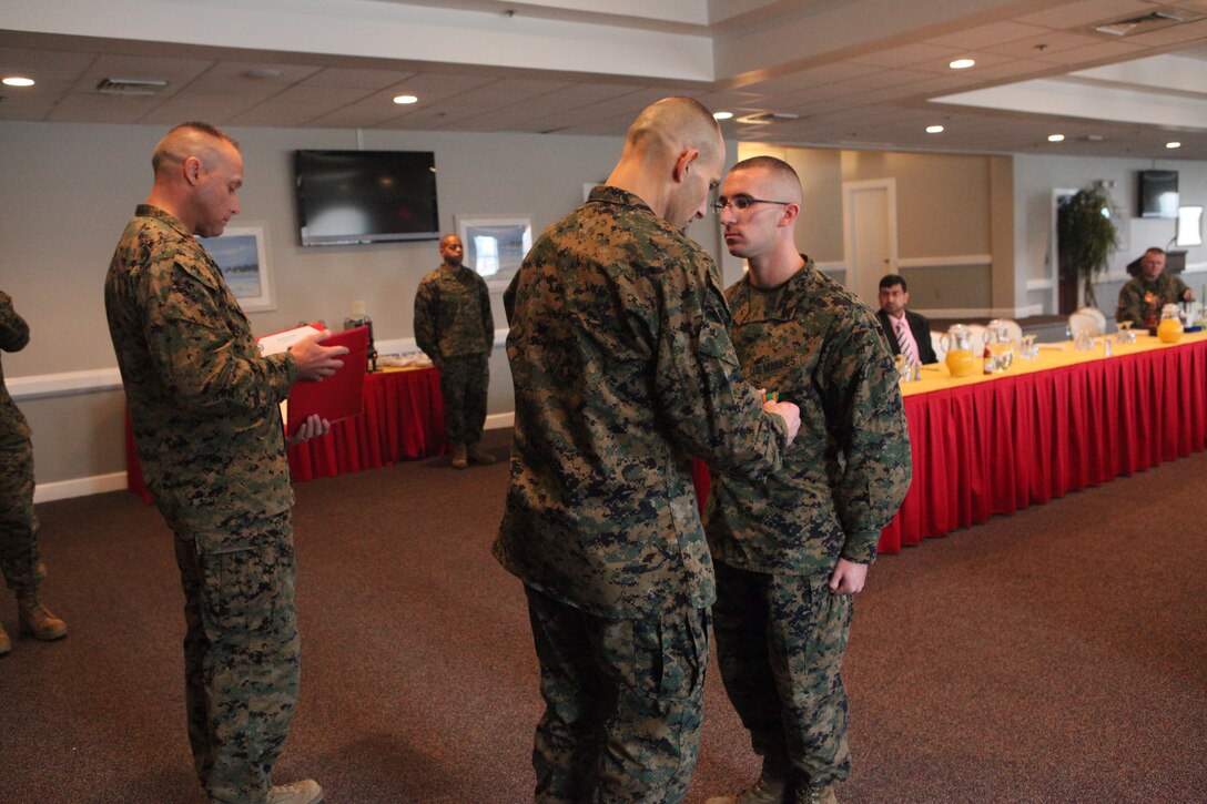 Cpl. Matthew S. Hamel, a distribution management specialist with Company A, Headquarters and Headquarters Squadron, Marine Corps Air Station Beaufort received athe Navy Marine Corps Achievement medal during the 6th annual Marine Corps Installations East breakfast hosted by Mainstreet at the Ball Center aboard Marine Corps Base Camp Lejeune, Jan. 9. Sgt. Robert F. Lark, an expeditionary airfields systems technician with Marine Wing Support Squadron 273, Marine Wing Support Group 27, 2nd Marine Aircraft Wing, Marine Corps Air Station Beaufort and Petty Officer 2nd Class Francisco Aquedamartinez, a corpsman with Deployment Processing Command-East, MCB Camp Lejeune also received the Navy Marine Corps Achievement medal.