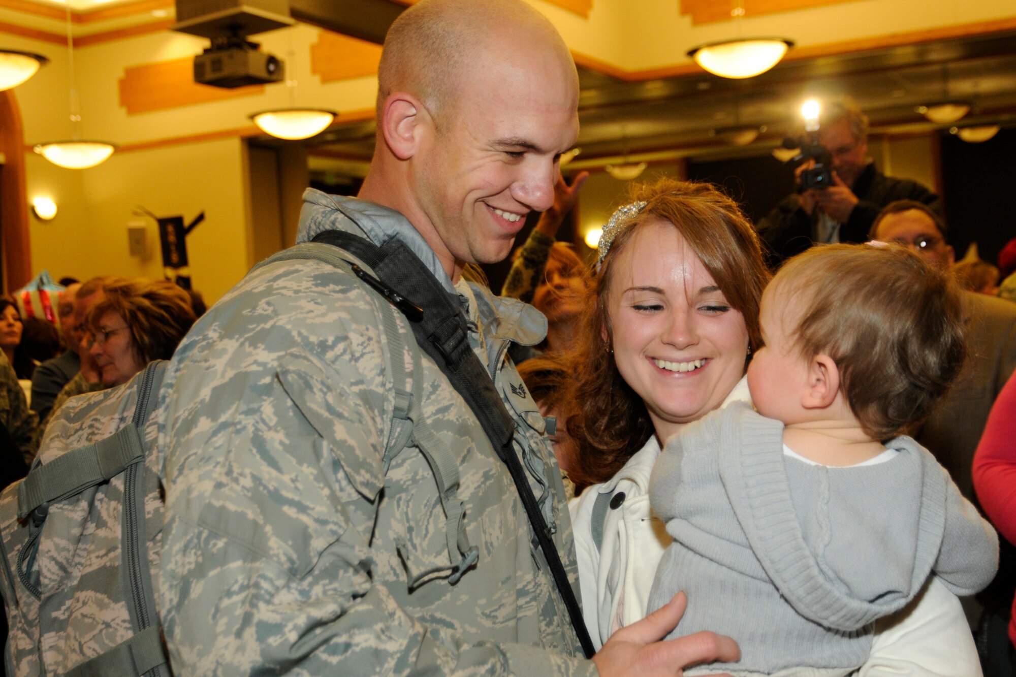 Staff Sergeant Daniel Blair, with the 127th Wing, is welcomed home by his wife, Amanda, and daughter Adaleigh, Jan. 9, 2012. SSgt. Blair, along with about 300 other members of the 127th Wing, returned home after a 4-month deployment to Afghanistan, where they flew, maintained and supported the A-10 Thunderbolt II aircraft. The Airmen are all members of the 127th Wing at Selfridge.  (U.S. Air Force photo by TSgt Dave Kujawa)

