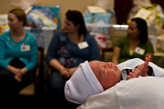 Jaxson McCausland, son of U.S. Air Force Senior Airman Timothy McCausland, 99th Force Support Squadron food service accountant and wife Cynthia McCausland, is held by a local volunteer during the Operation Showers of Appreciation at the Nellis Family Housing Community Center Jan. 7, 2012, at Nellis Air Force Base, Nev. McCausland was two days old during the shower, the first of many that members of the Operation Showers of Appreciation is planning to hold throughout the country for 2012. (U.S. Air Force photo by Airman 1st Class Daniel Hughes/Released)