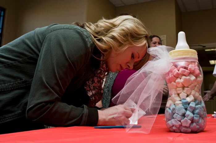 Rochelle Powell, wife of U.S. Air Force Staff Sgt. Michael Powell, 763rd Maintenance Squadron helicopter mechanic,  guesses how many star marsh mallows are in a baby bottle during Operation Showers of Appreciation at the Nellis Family Housing Community Center Jan. 7, 2012, at Nellis Air Force Base Nev. The Military Baby Shower is the first of many that members of the Operation Showers of Appreciation is planning to hold throughout the country for 2012. (U.S. Air Force photo by Airman 1st Class Daniel Hughes)