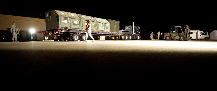 U.S. Air Force Airmen from the 116th and 461st Logistics Readiness Squadron load equipment on a flatbed truck late at Robins Air Force Base, Ga., Dec. 22, 2011.  The equipment was loaded on a C-5 Galaxy later that evening bound for Southwest Asia in support of missions being conducted by the 116th and 461st Air Control Wings.  (Air National Guard photo by Master Sgt. Roger Parsons/Released)