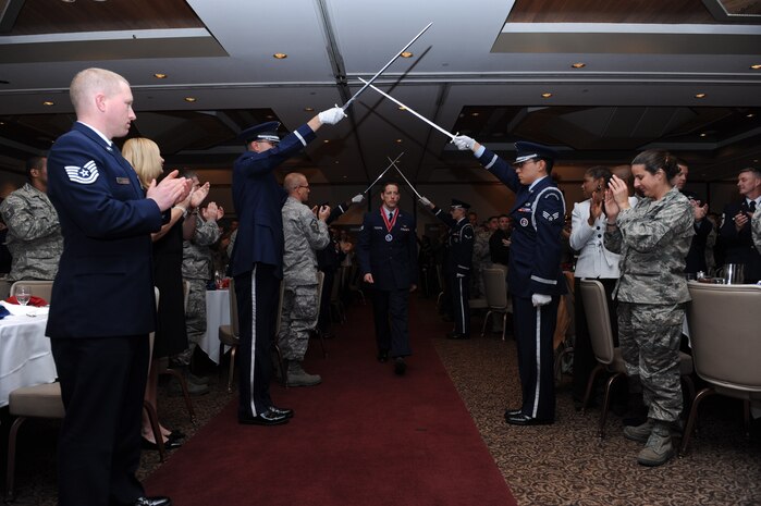 Senior Airman Jonathan Boley, a member of the 17th Reconnaissance Squadron, walks beneath the Nellis Honor Guard sword cordon after receiving the John L. Levitow Award during the Airman Leadership School graduation ceremony Dec. 22, 2011, on Nellis Air Force Base, Nev.  The Levitow Award is the highest award presented at all levels of enlisted Professional Military Education and is given to the top graduate in the class. (Courtesy photo)