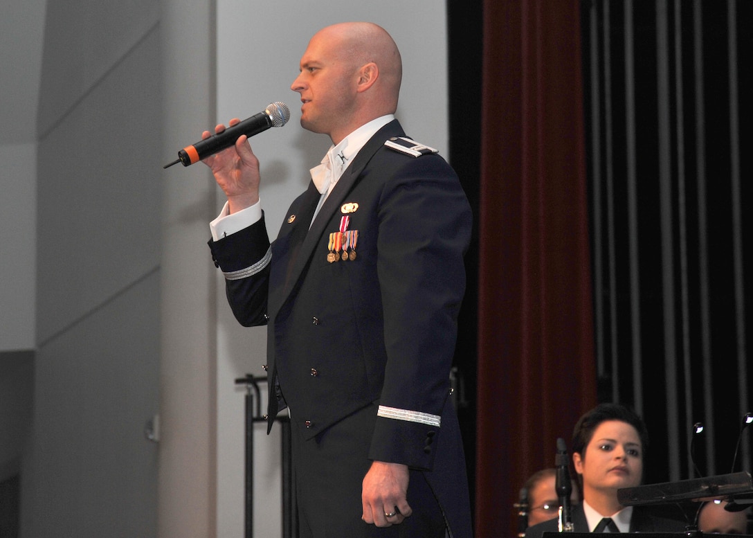 Captain Michael Hoerber introduces the guest emcee at Holiday in Blue
