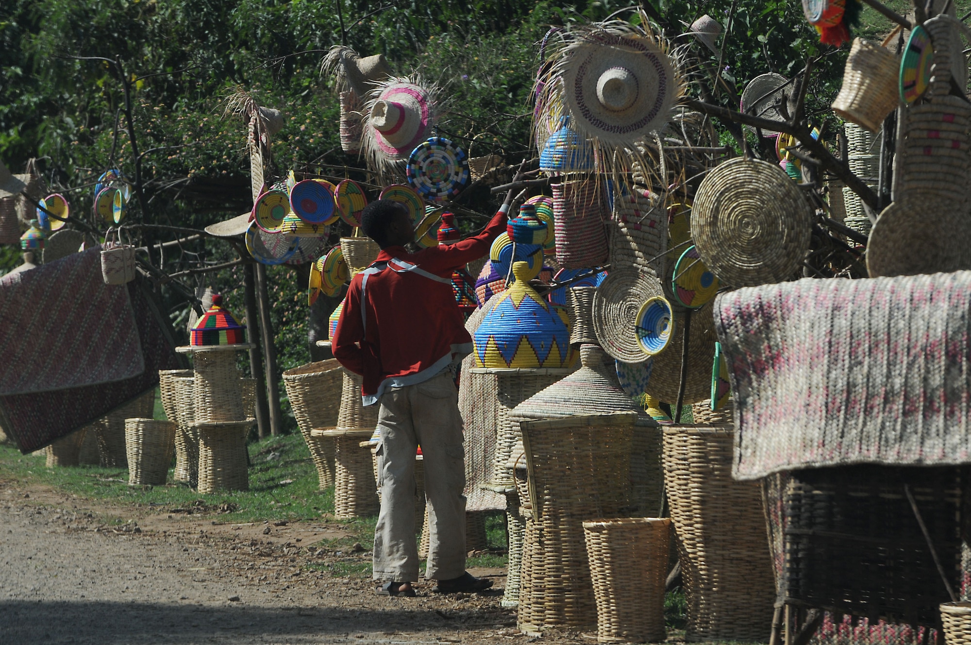 A boy looks at handwoven items for sale along the road to Negele Borena, Ethiopia, Dec. 5, 2011. Small markets and bazaars, which feature items from nearby farms and villages, are scattered along the unpaved road. (U.S. Air Force photo/Senior Airman Jarad Denton)