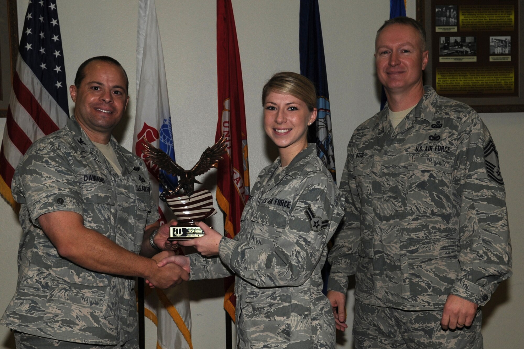 GOODFELLOW AIR FORCE BASE, Texas -- Col. Mark Damiano, 17th Training Wing Commander, and Chief Master Sgt. Quinton Otto, 17th Mission Support Group Superintendent, present the Team Gooodfellow Junior Enlisted of the Quarter award to Airman 1st Class Melanie White, 17th Medical Operations Squadron, during the wing quarterly awards ceremony Jan. 5. (U.S. Air Force photo/Staff Sgt. Laura R. McFarlane)