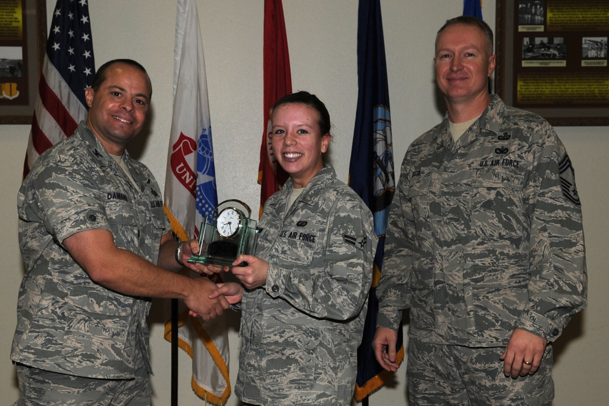 GOODFELLOW AIR FORCE BASE, Texas -- Col. Mark Damiano, 17th Training Wing Commander, and Chief Master Sgt. Quinton Otto, 17th Mission Support Group Superintendent, present the 17th Training Wing Dorm Room of the Quarter to Airman 1st Class Patricia Steimann, 17th Contracting Squadron, during the wing quarterly awards ceremony Jan. 5. (U.S. Air Force photo/Staff Sgt. Laura R. McFarlane)