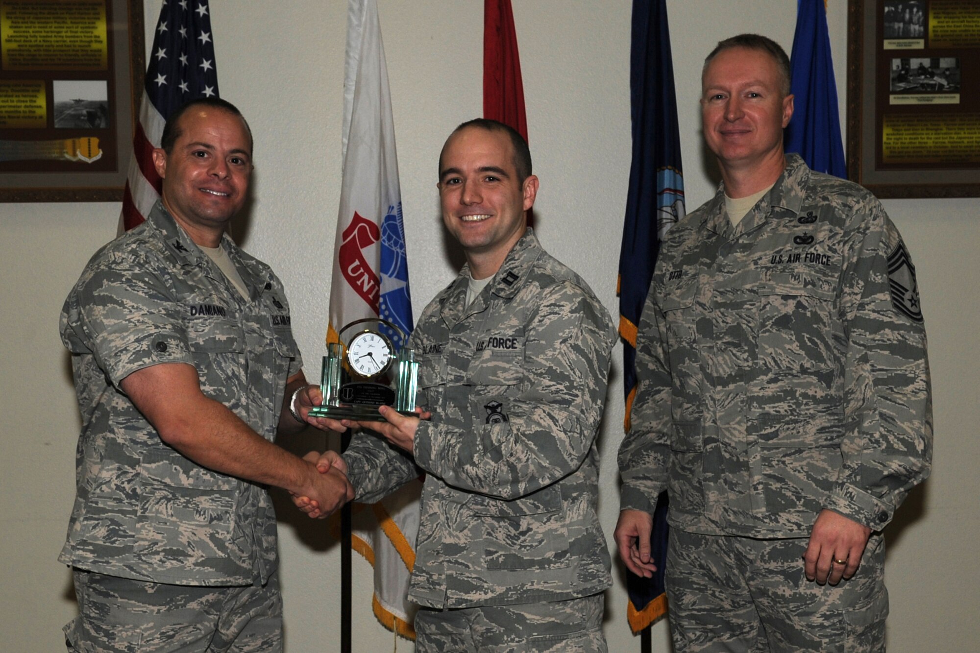 GOODFELLOW AIR FORCE BASE, Texas -- Col. Mark Damiano, 17th Training Wing Commander, and Chief Master Sgt. Quinton Otto, 17th Mission Support Group Superintendent, present the 17th Training Wing Company Grade Officer of the Quarter to Capt. Anthony Blaine, 17th Security Forces Squadron, during the wing quarterly awards ceremony Jan. 5. (U.S. Air Force photo/Staff Sgt. Laura R. McFarlane)