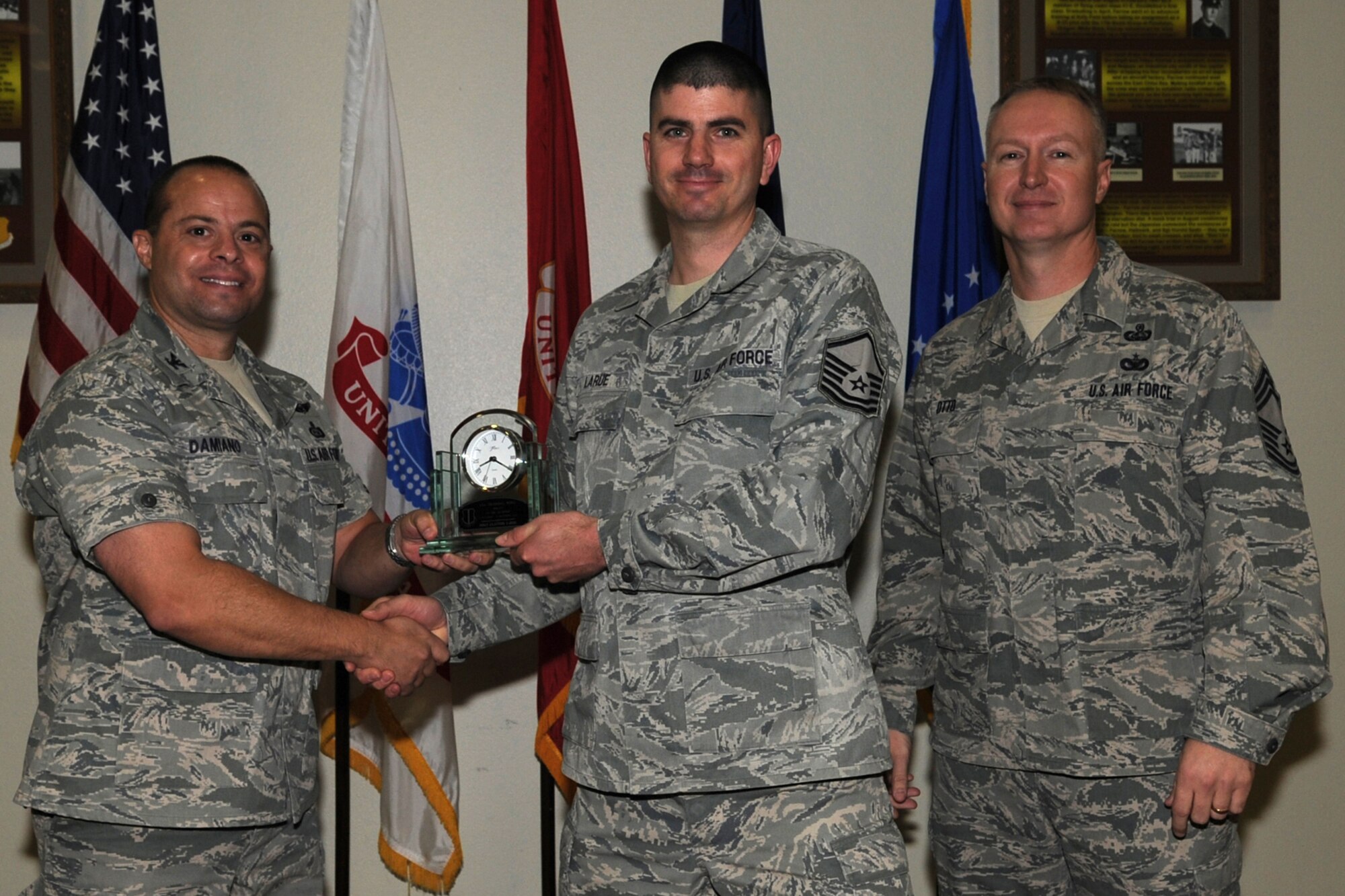 GOODFELLOW AIR FORCE BASE, Texas -- Col. Mark Damiano, 17th Training Wing Commander, and Chief Master Sgt. Quinton Otto, 17th Mission Support Group Superintendent, present the 17th Training Wing Senior NCO of the Quarter to Master Sgt. Clayton LaRue, 17th Communications Squadron, during the wing quarterly awards ceremony Jan. 5. (U.S. Air Force photo/Staff Sgt. Laura R. McFarlane)
