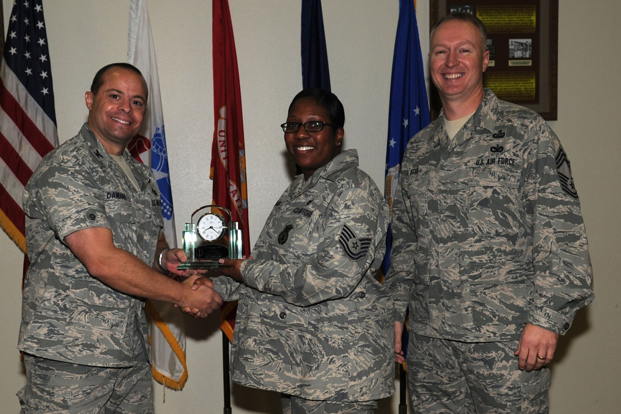 GOODFELLOW AIR FORCE BASE, Texas -- Col. Mark Damiano, 17th Training Wing Commander, and Chief Master Sgt. Quinton Otto, 17th Mission Support Group Superintendent, present the 17th Training Wing NCO of the Quarter to Tech. Sgt. Sabrina Lukas, 17th Security Forces Squadron, during the wing quarterly awards ceremony Jan. 5. (U.S. Air Force photo/Staff Sgt. Laura R. McFarlane)