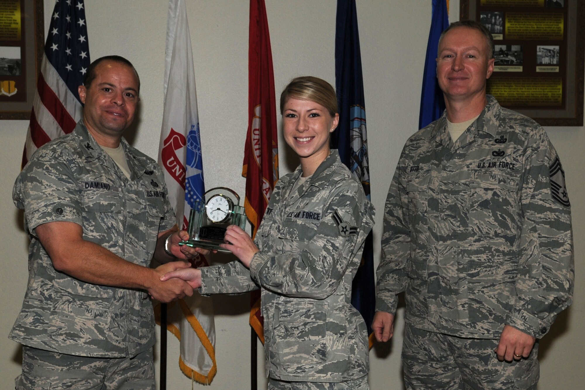 GOODFELLOW AIR FORCE BASE, Texas -- Col. Mark Damiano, 17th Training Wing Commander, and Chief Master Sgt. Quinton Otto, 17th Mission Support Group Superintendent, present the 17th Training Wing Airman of the Quarter to Airman 1st Class Melanie White, 17th Medical Operations Squadron, during the wing quarterly awards ceremony Jan. 5. (U.S. Air Force photo/Staff Sgt. Laura R. McFarlane)