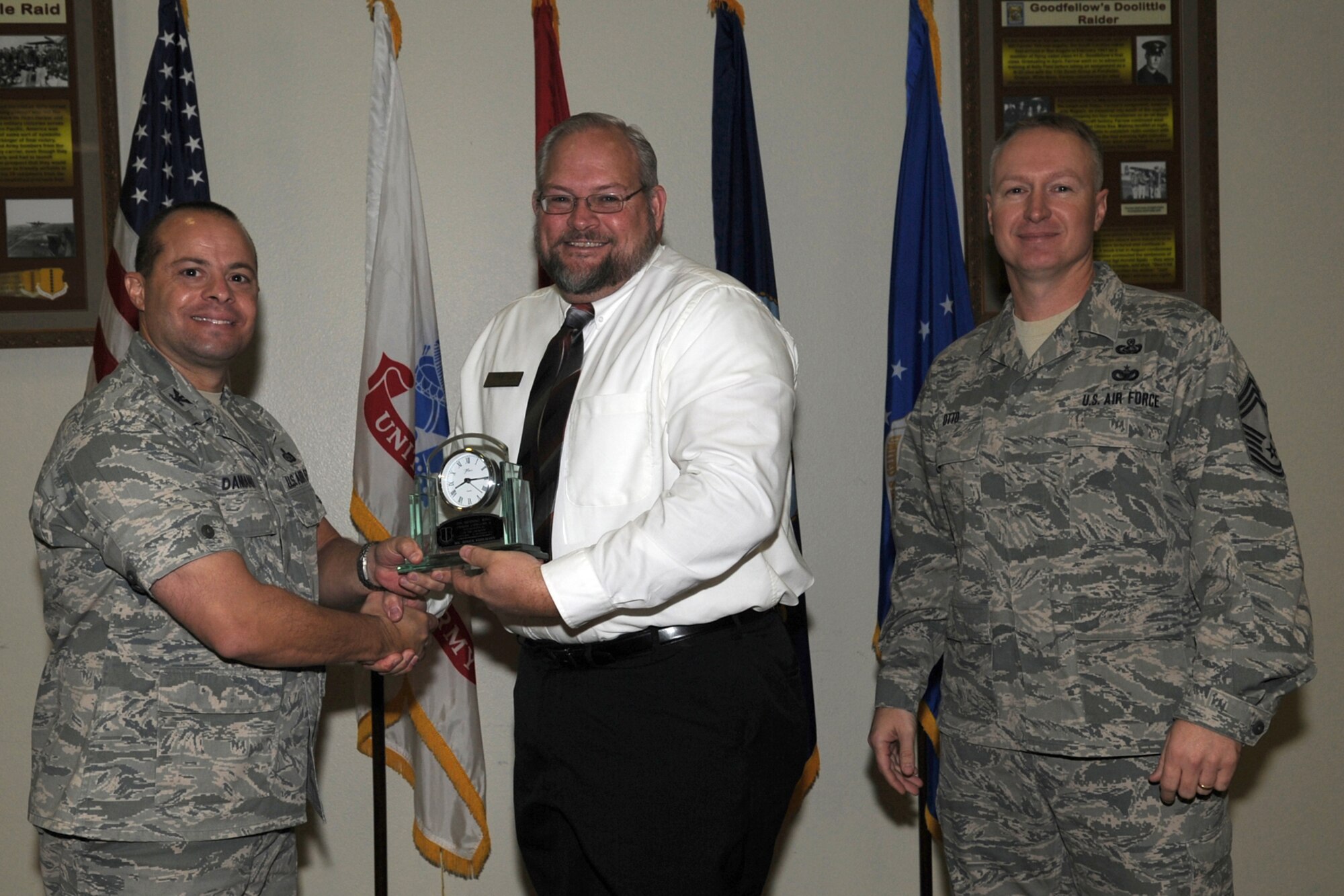 GOODFELLOW AIR FORCE BASE, Texas -- Col. Mark Damiano, 17th Training Wing Commander, and Chief Master Sgt. Quinton Otto, 17th Mission Support Group Superintendent, present the 17th Training Wing Civilian of the Quarter Category II to Roger Kuhlmann, 17th Force Support Squadron, during the wing quarterly awards ceremony Jan. 5. (U.S. Air Force photo/Staff Sgt. Laura R. McFarlane)