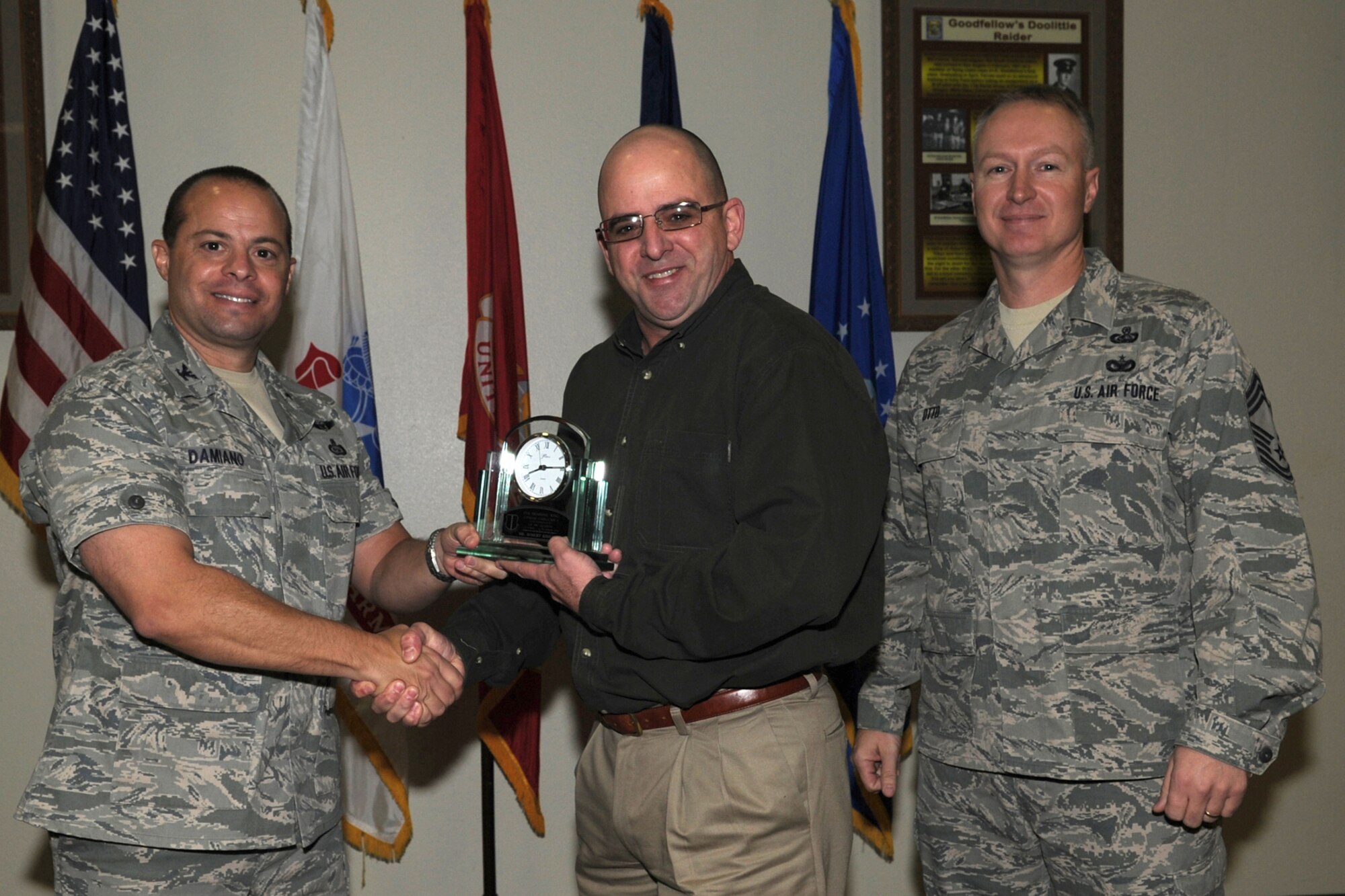 GOODFELLOW AIR FORCE BASE, Texas -- Col. Mark Damiano, 17th Training Wing Commander, and Chief Master Sgt. Quinton Otto, 17th Mission Support Group Superintendent, present the 17th Training Wing Civilian of the Quarter Category I to Robert Kibiloski, 17th Logistics Readiness Squadron, during the wing quarterly awards ceremony Jan. 5. (U.S. Air Force photo/Staff Sgt. Laura R. McFarlane)