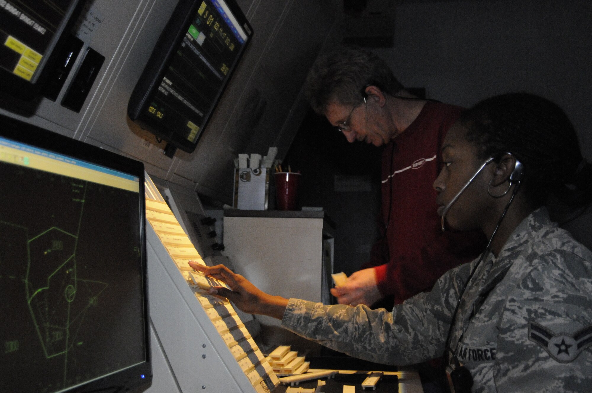 Airman 1st Class Leah Ned and civilian air traffic controller Dave Holmberg prepare computer print-outs prior to beginning a training exercise at Selfridge Air National Guard Base, Mich., Jan. 8, 2012. Ned, a member of the Louisiana Air National Guard, is in training to be certified as an air traffic controller. Selfridge is one of several locations in the Air National Guard where air traffic control trainees receive the hands-on portion of their training to become certified as controllers by the Federal Aviation Administration. (U.S. Air Force photo by TSgt. David Kujawa)