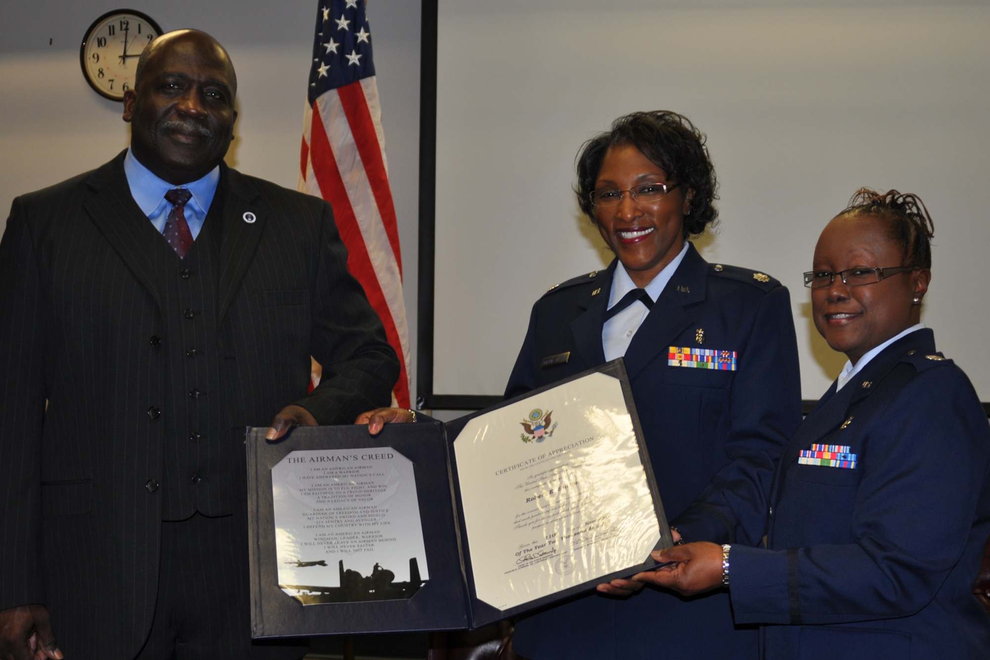 Retired Air Force Tech. Sgt. Robert Sutton, husband of retired Lt. Col. Corine Barral-Sutton, and Lt. Col. Beverly Lewis, a clinical nurse assigned to the 307th Medical Squadron, pose for a photo during retirement ceremonies at Barksdale Air Force Base, La., Jan. 7, 2012. Barral-Sutton, who was assigned to the 307th MDS retired after 23 years of service. (U.S. Air Force photo by Master Sgt. Jeff Walston/Released)      