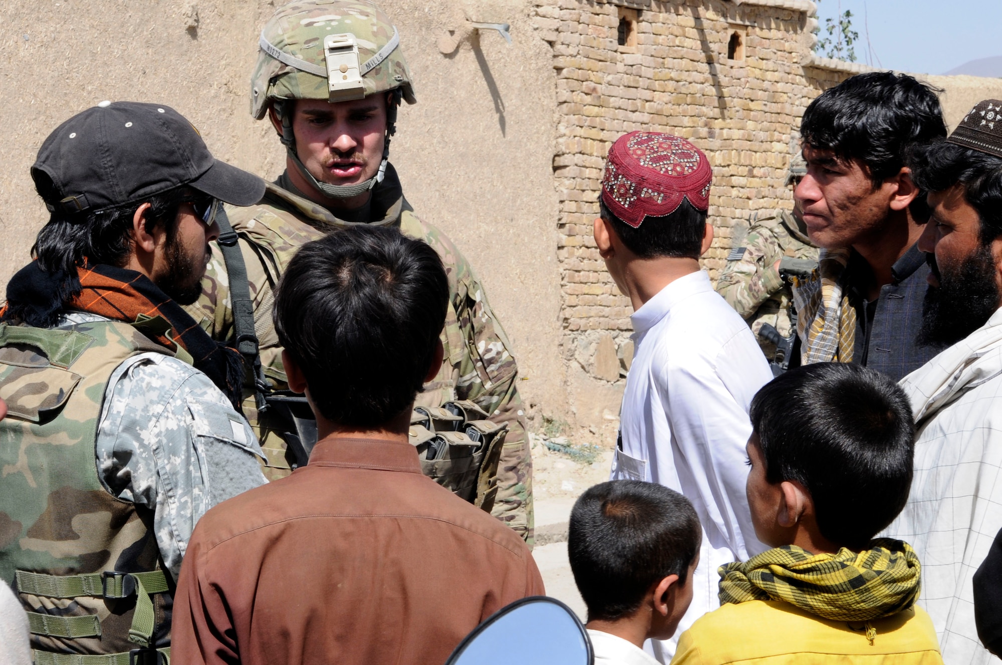 PAKTYA PROVINCE, Afghanistan-- U.S. Air Force 1st Lt. Ryan Mills talks to children in Paktya Province, Afghanistan, Sept. 26, 2011. Mills is a Paktya PRT intelligence officer from Chicago, Ill.  He received his commission from the United States Air Force Academy in 2008 with a degree in legal studies. (U.S. Air Force photo / 1st Lt. Cammie Quinn, Paktya PRT Public Affairs)  