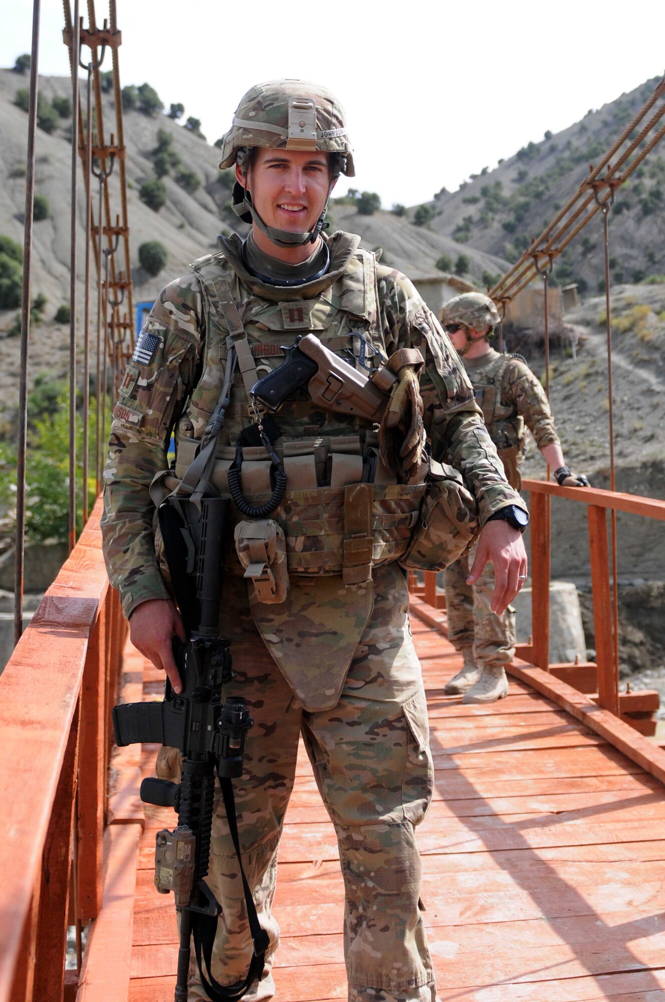 PAKTYA PROVINCE, Afghanistan-- U.S. Air Force Capt. Tyler Johnson crosses a bridge in Waze Zadran District during a quality assurance inspection in Paktya Province, Afghanistan Aug. 28, 2011.  Johnson is a Paktya PRT lead engineer from San Antonio, Texas.  Johnson received his commission from the United States Air Force Academy in 2005, where he studied civil engineering. (U.S. Air Force photo/ 1st Lt. Cammie Quinn, Paktya PRT Public Affairs)  
