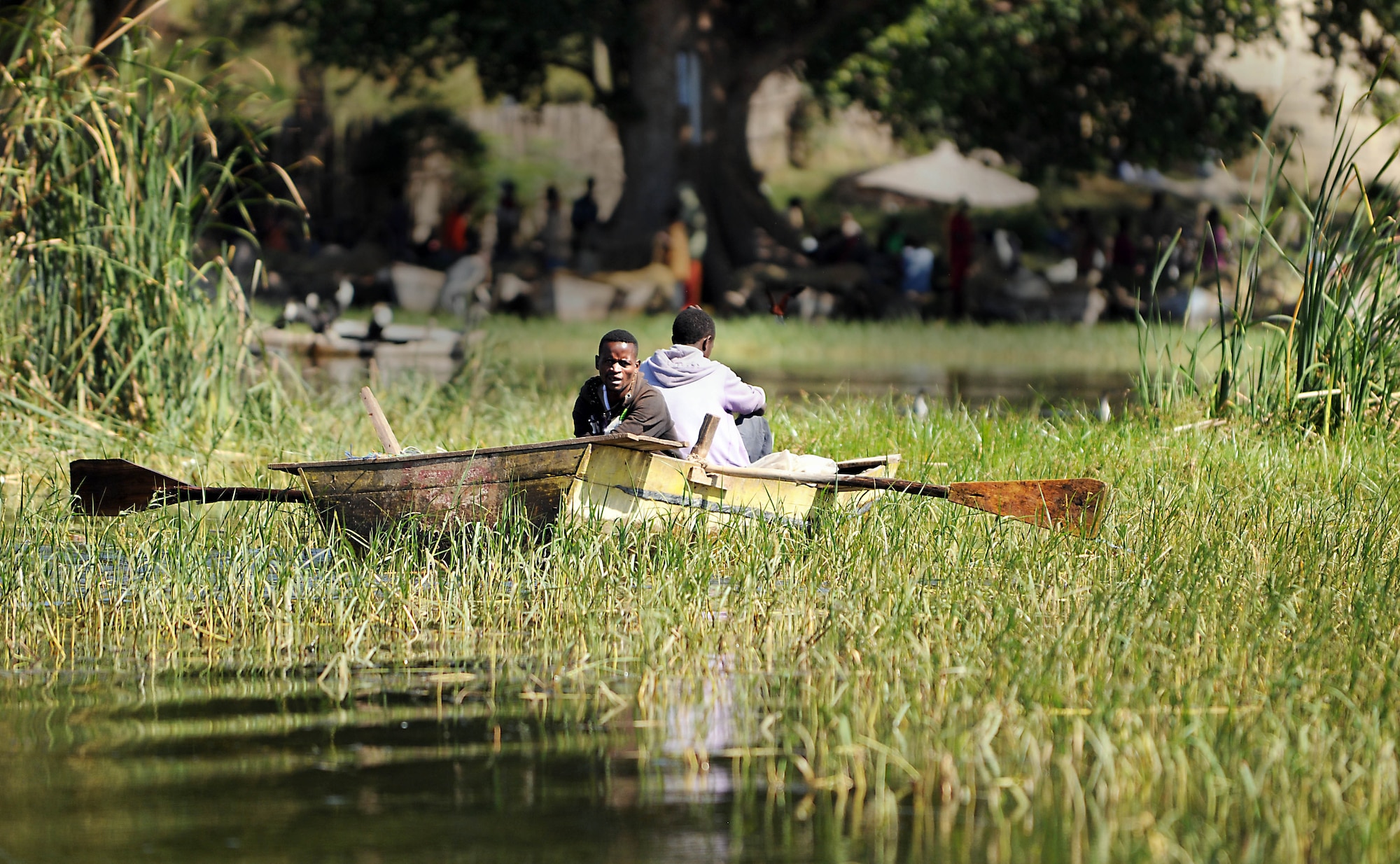 Two fishermen guide their handmade boat toward the fish market in Hawassa, Ethiopia, Dec. 8, 2011. The fish caught from the adjacent lake are sold to residents both in town and in the surrounding villages. (U.S. Air Force photo/Senior Airman Jarad Denton)