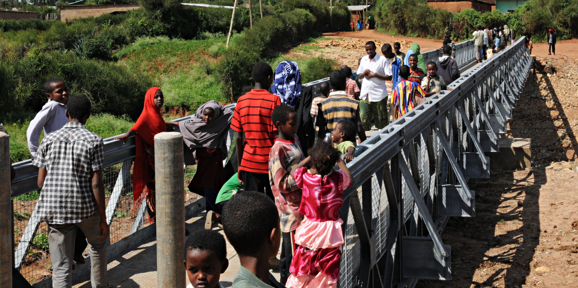 Residents of Negele Borena, Ethiopia, line up to cross the recently dedicated town bridge Dec. 6, 2011. The bridge was built as a means for pedestrians and livestock to cross a dangerous river. (U.S. Air Force photo/Senior Airman Jarad Denton)