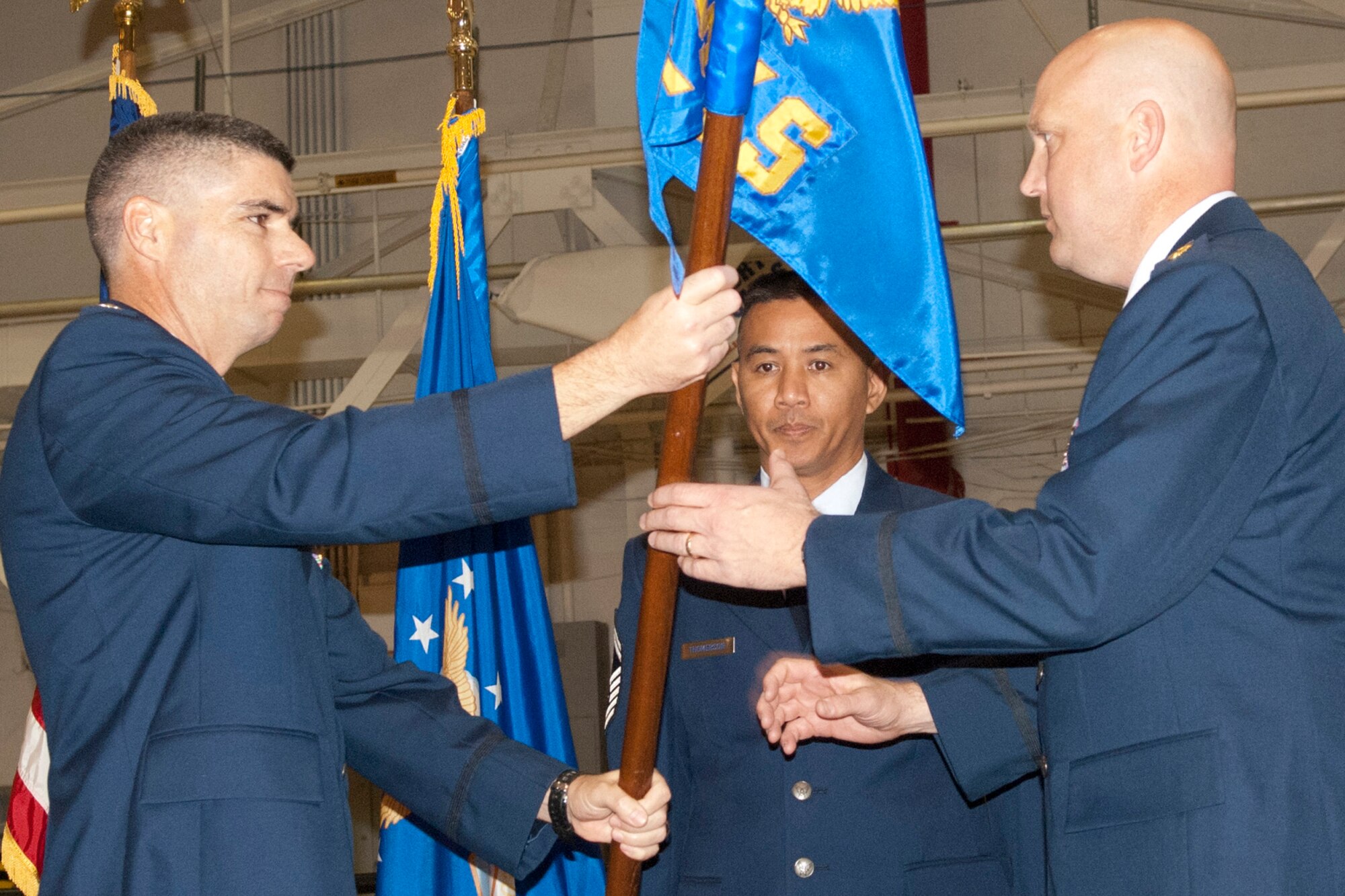 Lt. Col. Kenneth Rose, the 307th Maintenance Group commander, hands a guidon to Maj. Karwin Weaver, the 307th Aircraft Maintenance Squadron commander during an assumption of command ceremony at Barksdale Air Force Base, La., Jan. 7, 2012.  Weaver most recently served as the 44th Aircraft Maintenance Squadron at Holloman AFB, N.M. (U.S. Air Force Photo by Staff Sgt. Ted Daigle/Released)