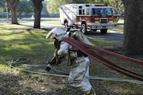 Airman 1st Class John Evans, Joint Base San Antonio-Randolph Fire Emergency Services firefighter, pulls a hose from a fire truck during a training exercise Dec. 7. For complete coverage of the training, see page 6. (U.S. Air Force Photo/Don Lindsey)