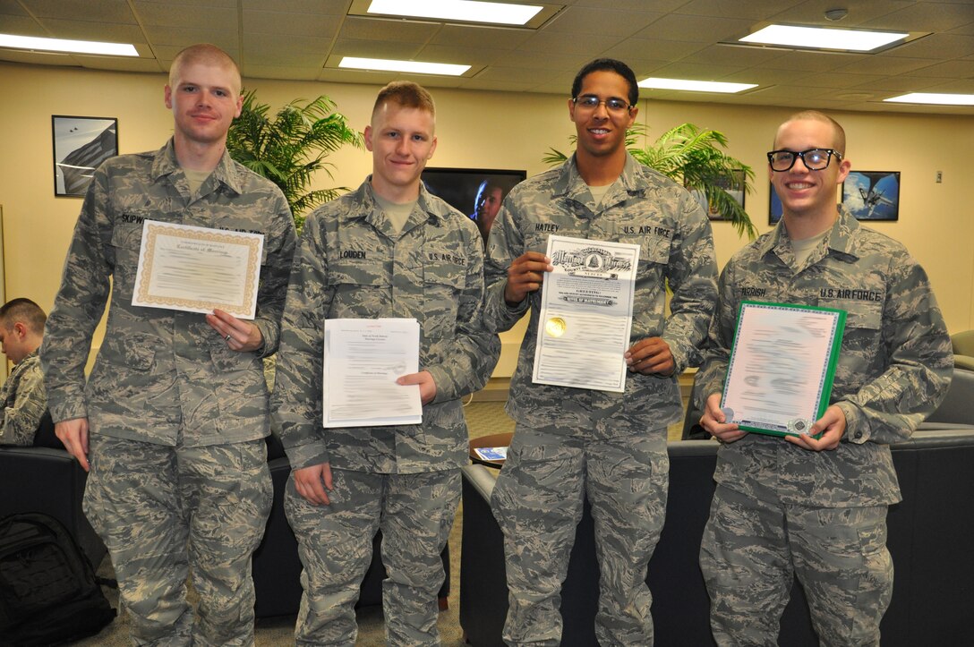 Newlywed Airmen display their marriage certificates during Marriage Day Jan. 7, 2012. Sheppard Air Force Base holds Marriage Day as a streamlined process to update paperwork for Airmen married over the holidays; this year, over 100 Airmen took advantage of the event. (U.S. Air Force photo/2nd Lt. Sara Harper)