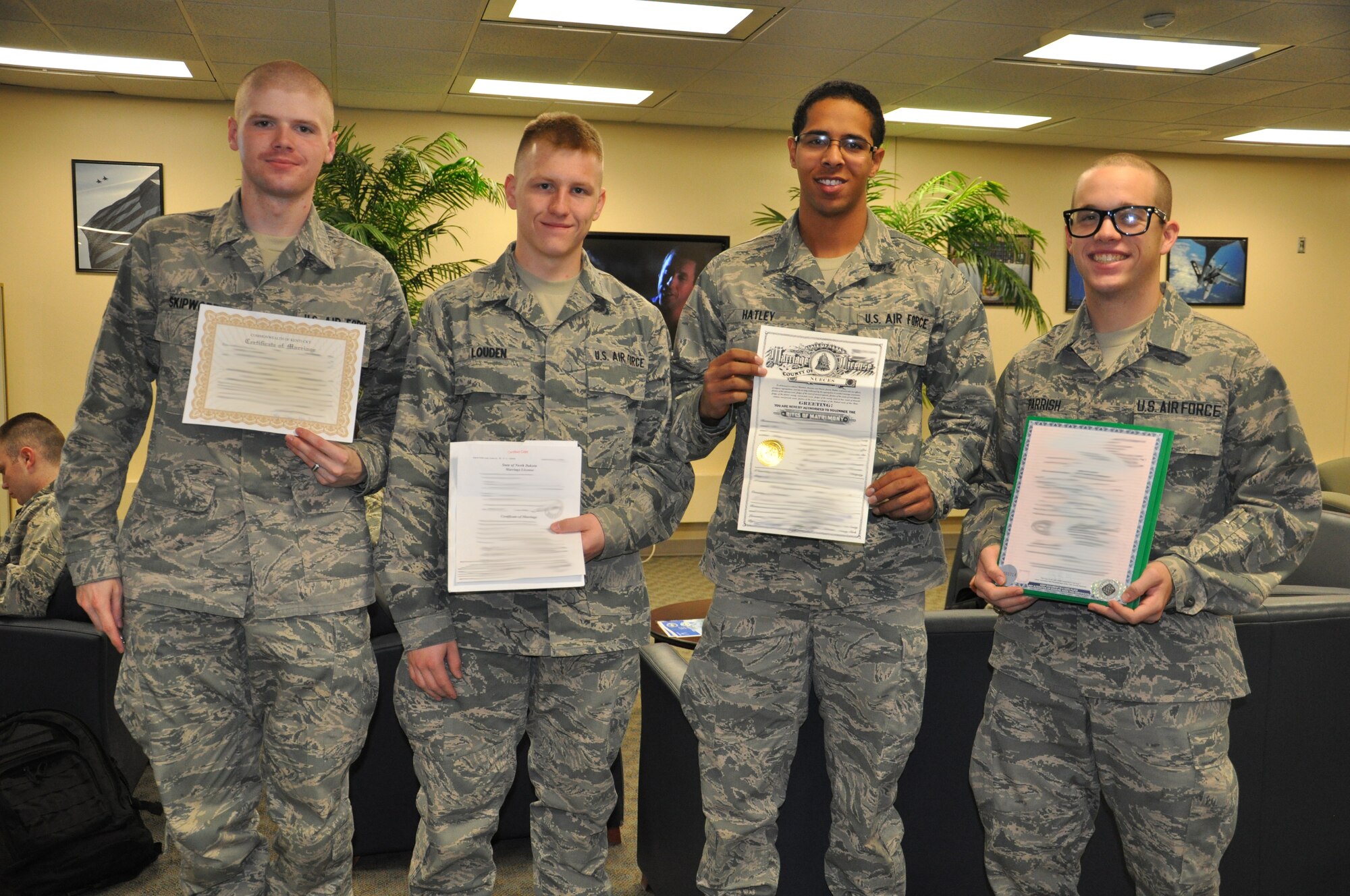 Newlywed Airmen display their marriage certificates during Marriage Day Jan. 7, 2012. Sheppard Air Force Base holds Marriage Day as a streamlined process to update paperwork for Airmen married over the holidays; this year, over 100 Airmen took advantage of the event. (U.S. Air Force photo/2nd Lt. Sara Harper)