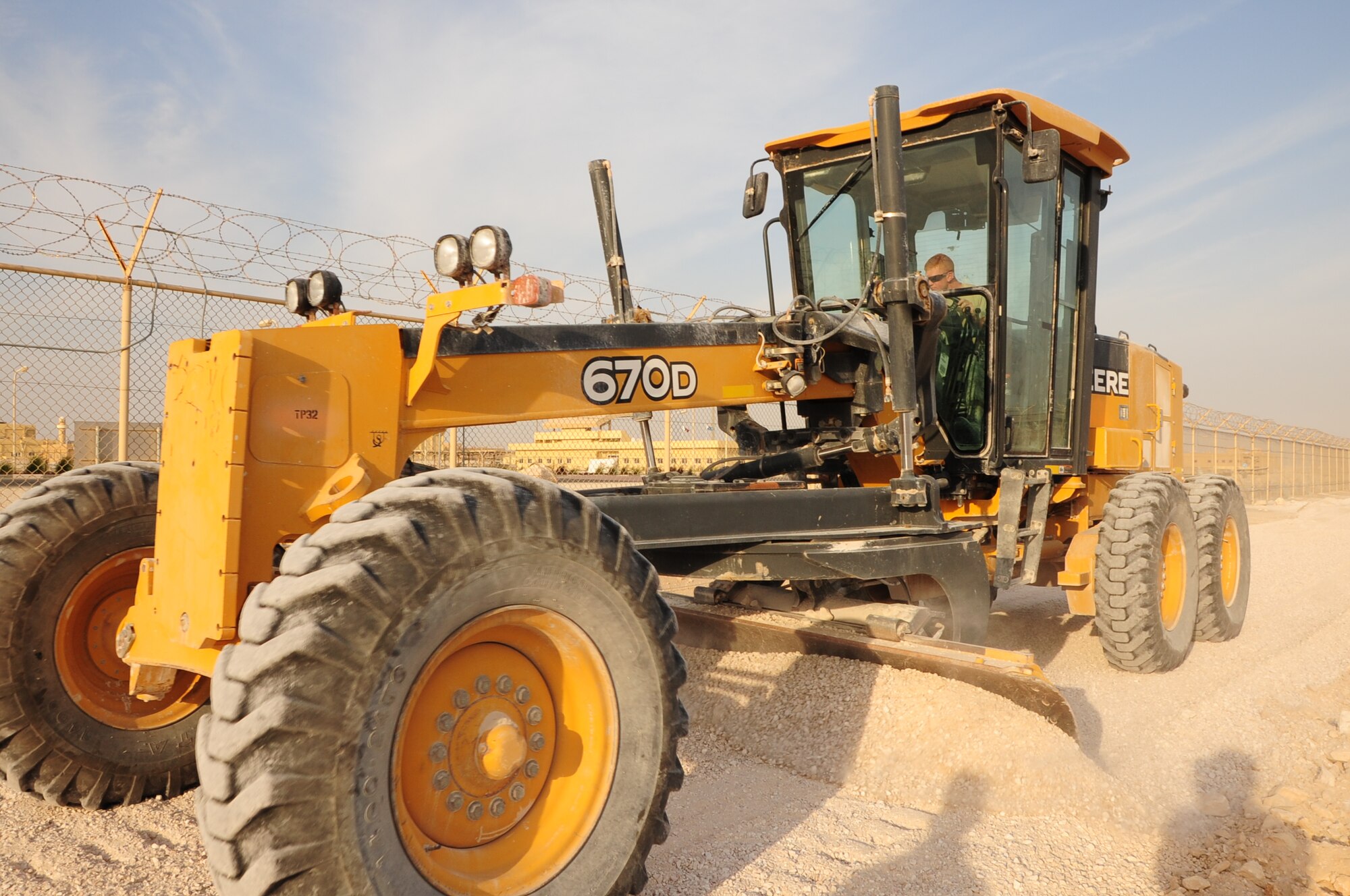 Airman 1st Class Andrew Hamm, 379th Expeditionary Civil Engineer Squadron Dirt Boyz team member and native of Taylorville, Ill., levels an area Jan. 5 where a new five-mile track will be built. The track, slated for completion in the spring, will surround the Coalition Compound and the Blatchford-Preston Complex. Hamm is deployed from Fairchild Air Force Base, Wash. (U.S. Air Force photo/Senior Airman Michael Charles)

