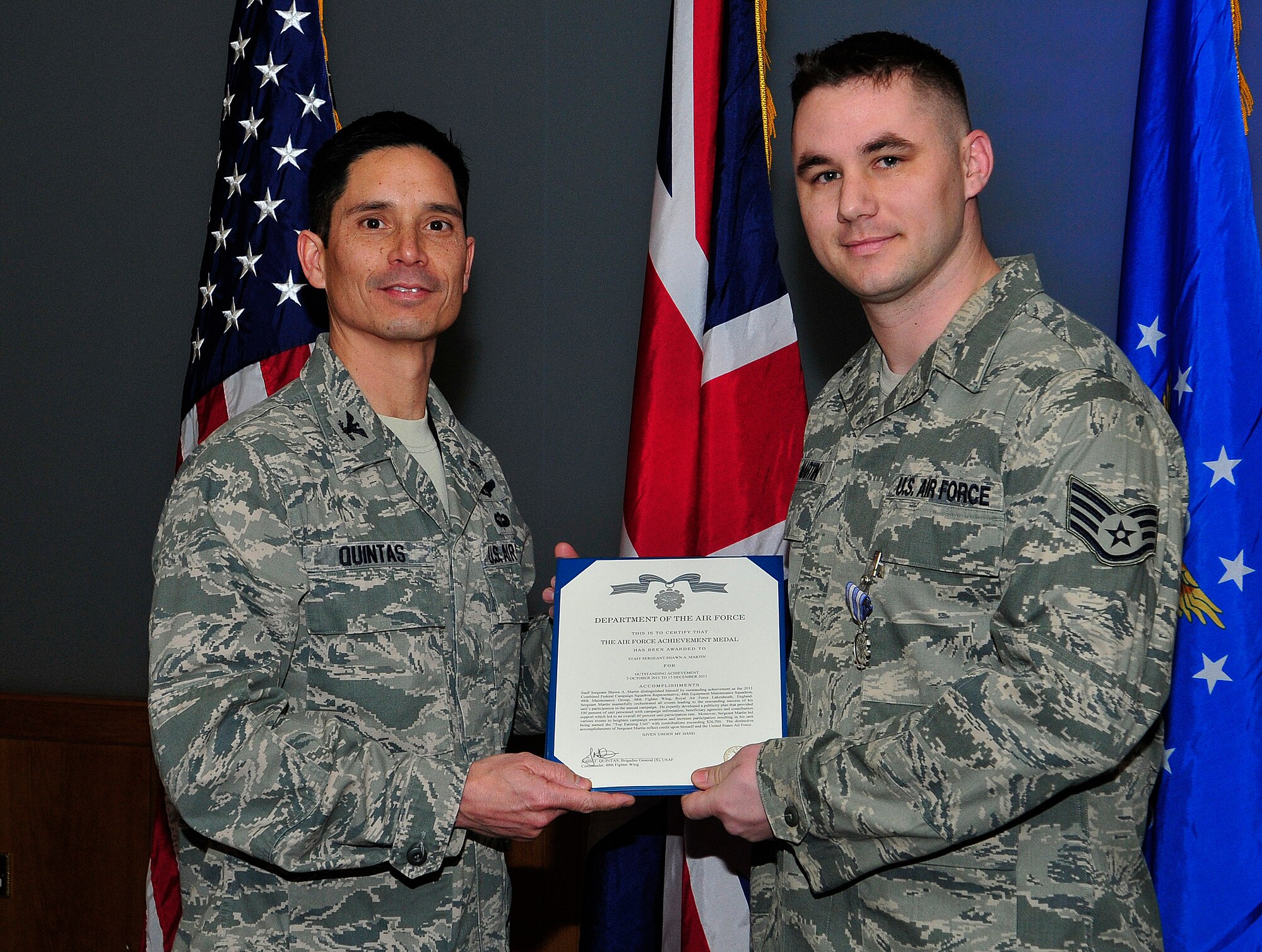 ROYAL AIR FORCE LAKENHEATH, England - Col. John Quintas, 48th Fighter Wing commander, presents an Air Force Achievement Medal to Staff Sgt. Shawn Martin, 48th FW Safety Office motorcycle safety coordinator and Combined Federal Campaign representative for the 48th Equipment Maintenance Squadron, for his accomplishments during the CFC, Dec. 20, 2011. Martin led many events for the CFC and helped raise $26,763. (U.S. Air Force photo by Senior Airman Tiffany M. Deuel) 