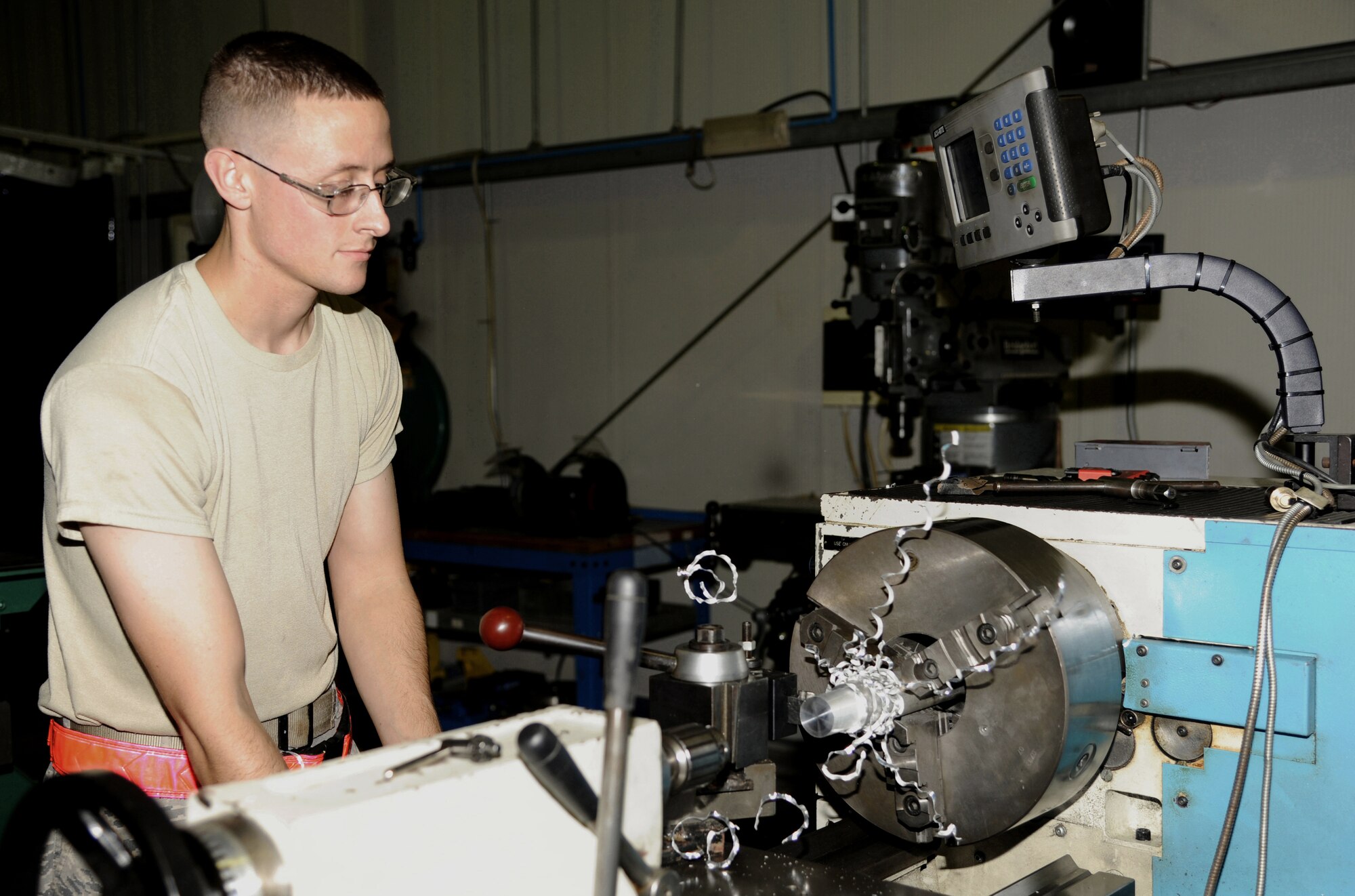 SOUTHWEST ASIA - Senior Airman Andrew Rahke creates a bushing with a lathe machine at the fabrication flight Jan. 6, 2012. Rahke is deployed from Kadena Air Base, Japan and assigned to the 380th Expeditionary Maintenance Squadron. (U.S. Air Force photo/Tech. Sgt. Arian Nead) 