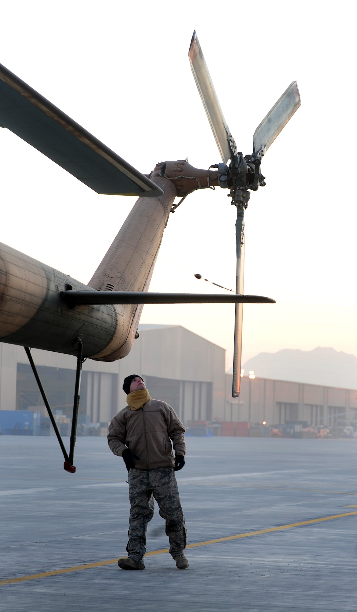 Tech. Sgt. Matthew Chambers, a flight engineer with the 438th Air Expeditionary Advisory Squadron, performs a walk around inspection of an Afghan air force MI-17 helicopter prior to a supply flight over northern Afghanistan, Dec. 21, 2011, at Kabul International Airport. Chambers is currently deployed to provide advisory training for Afghan air force flight engineers. (U.S. Air Force photo by Staff Sgt. Nadine Y. Barclay)