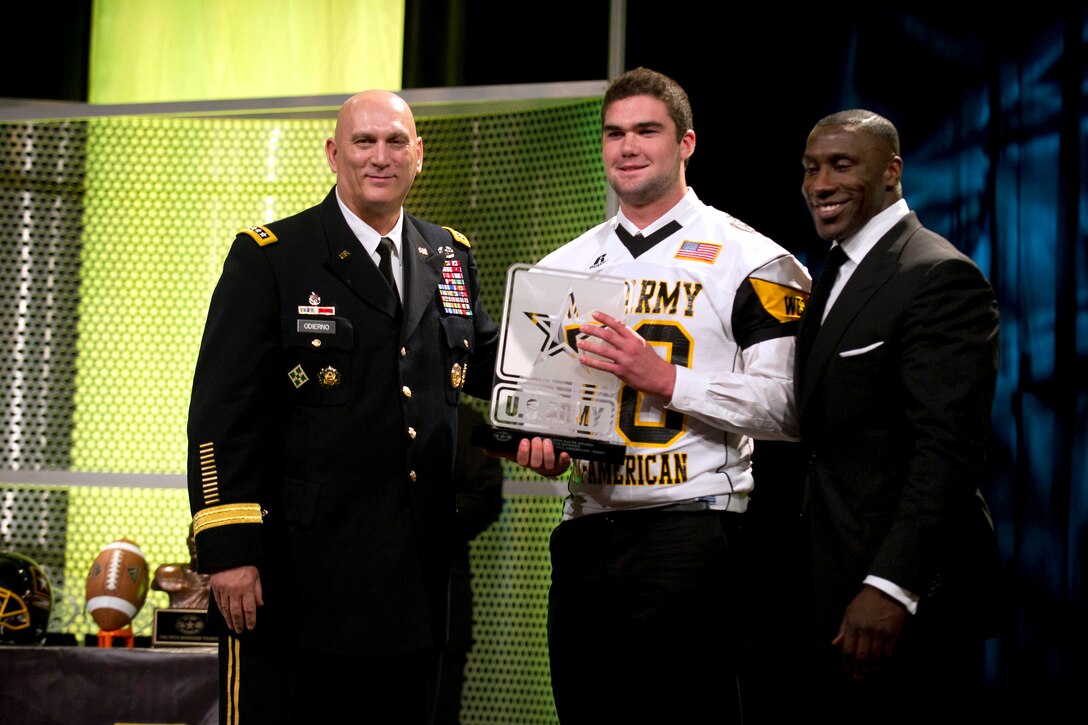 Army Chief of Staff Gen. Raymond T. Odierno and Shannon Sharpe, right, present the Glen Davis Award to Kyle Murphy, an offensive linemen, during the Army All-American Bowl Awards Dinner in San Antonio, Jan. 6, 2012.