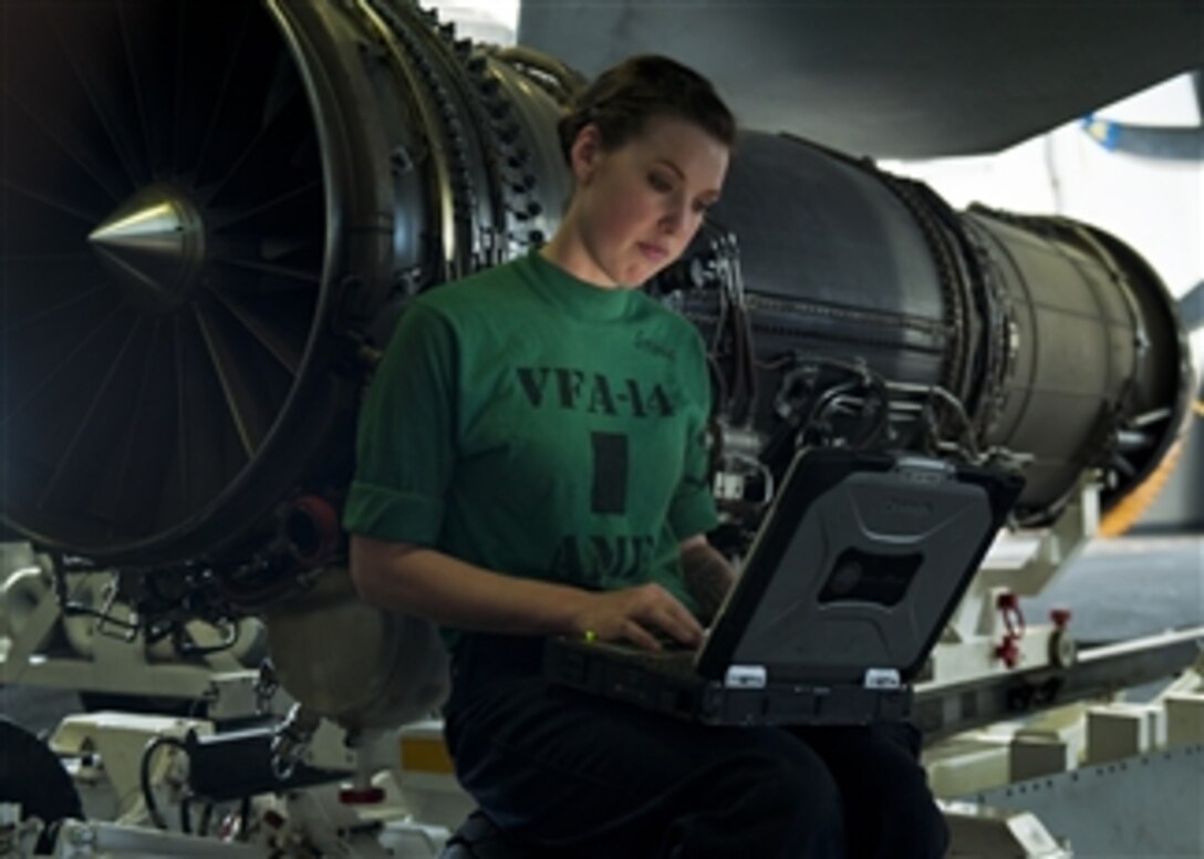 Petty Officer 3rd Class Sarah Stone reads the instructions for installing a fire bottle into an F/A-18E Super Hornet from Strike Fighter Squadron 14 aboard the aircraft carrier USS John C. Stennis (CVN 74) in the Arabian Sea on Jan. 6, 2012.  The John C. Stennis is deployed to the U.S. 5th Fleet area of responsibility conducting maritime security operations and support missions as part of Operation Enduring Freedom.  