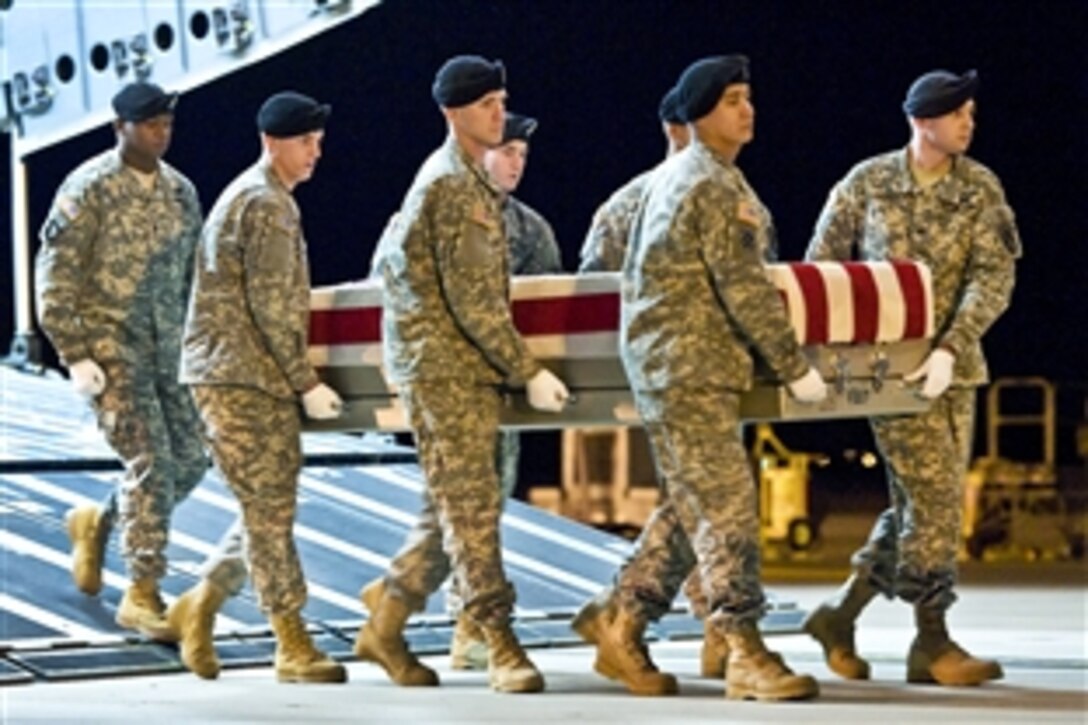 Army soldiers transfer the remains of Army Spc. Christopher A. Patterson on Dover Air Force Base, Del., Jan. 8, 2012. Patterson was assigned to the 713th Engineer Company, Indiana National Guard.