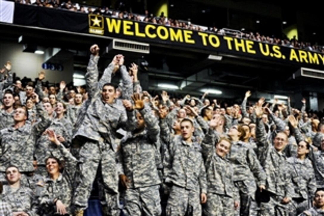 Army soldiers jump to catch mini-footballs during the Army All-American Bowl at the Alamodome in San Antonio, Jan. 7, 2012. The soldiers are assigned to advanced individual training units.