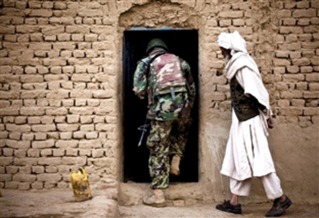 An Afghan soldier enters an elder's home while clearing compounds with U.S. Marines during Operation Tageer Shamal in Afghanistan's Helmand province, Jan. 4, 2012. In recent years, Afghan and coalition forces have operated side by side, driving insurgents from populated areas in southern Helmand. The Marines are assigned to Lima Company, 3rd Battalion, 3rd Marine Regiment.