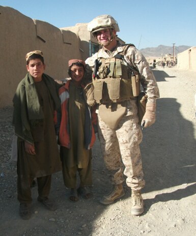 Col. Yori R. Escalante, the assistant chief of staff C-9 for Regional Command Southwest, poses for a picture with two Afghan children in Now Zad, Helmand province, Afghanistan, Jan. 11, 2012. Escalante and other members of his team were in the area for a meeting with district officials and used their spare time to socialize with the local population.