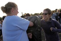 Amy Stewart, a teacher at Armstrong High School, holds a punching bag while Kaila Sawochka, a teacher at Chanhassen High School, practices her new Marine Corps Martial Arts skills Jan. 10 during the Recruiting Station Twin Cities 2012 Educators Workshop. For additional imagery from the event, visit www.facebook.com/rstwincities.